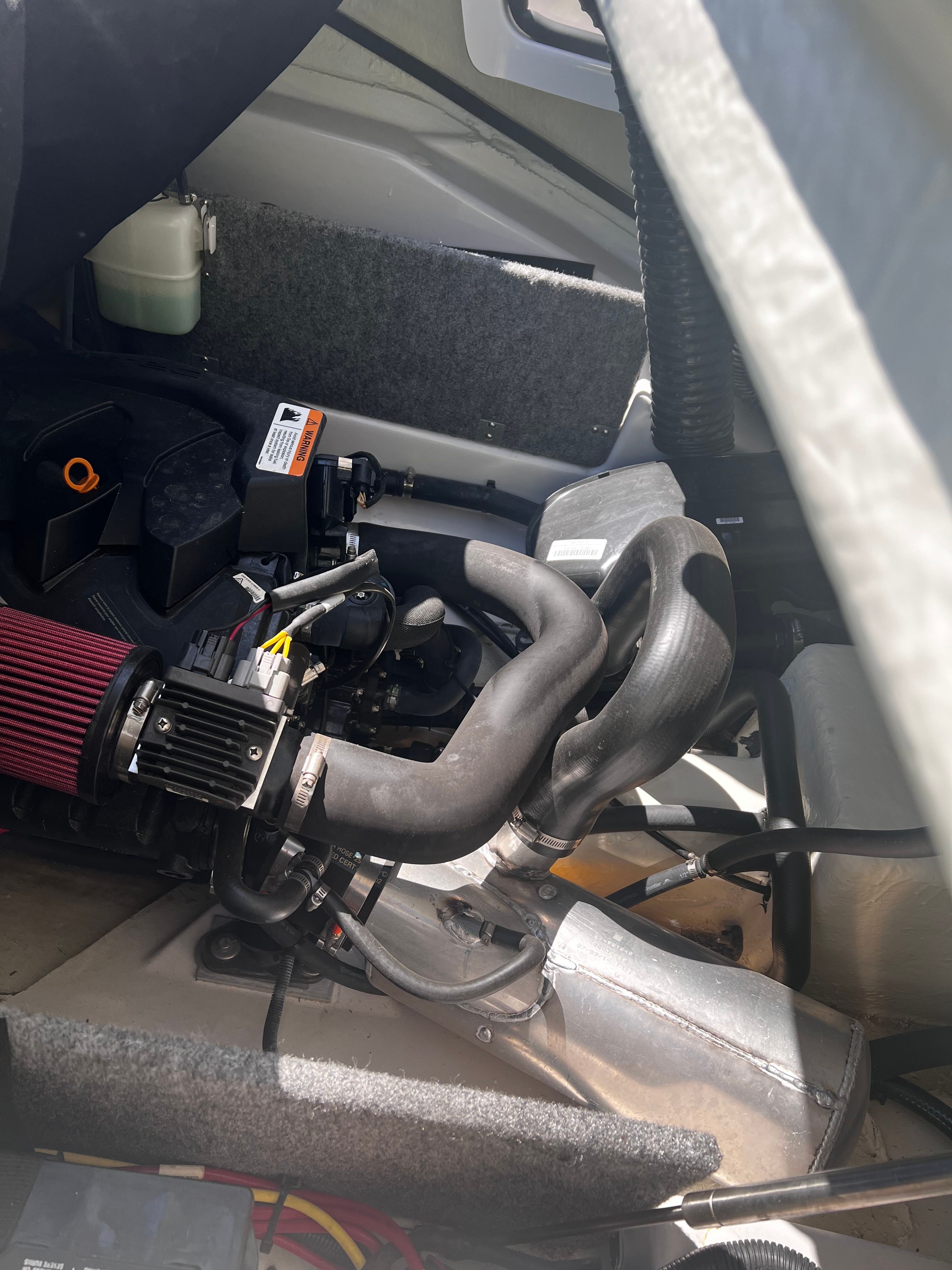 An engine compartment of a boat with visible engine and components.