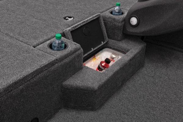 The image shows the interior of a Tracker Pro Team 175 TXW boat with cup holders and a storage compartment.