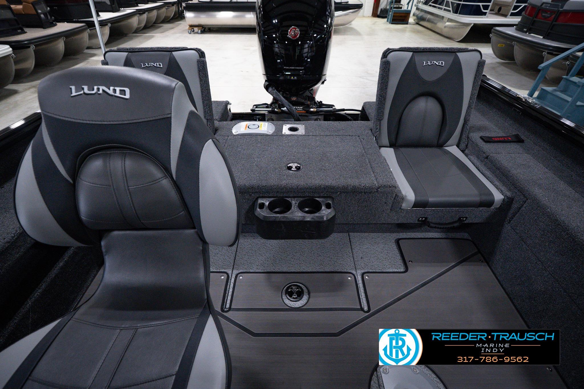 2026 Lund 1875 Impact XS SS boat interior with gray seating and storage compartments.