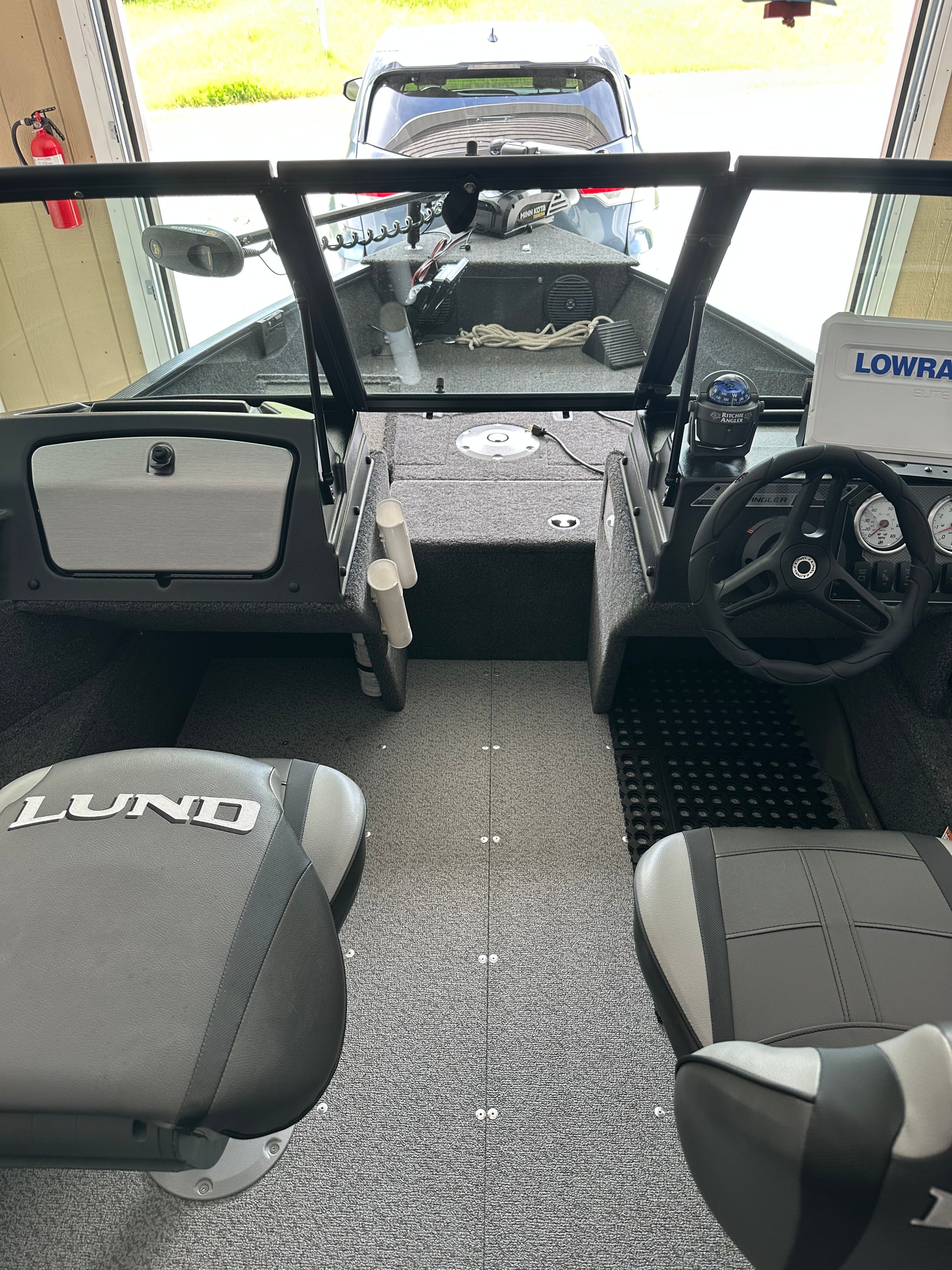 Interior view of a 2025 Lund Pro Angler 1650 with two seats and a helm station.