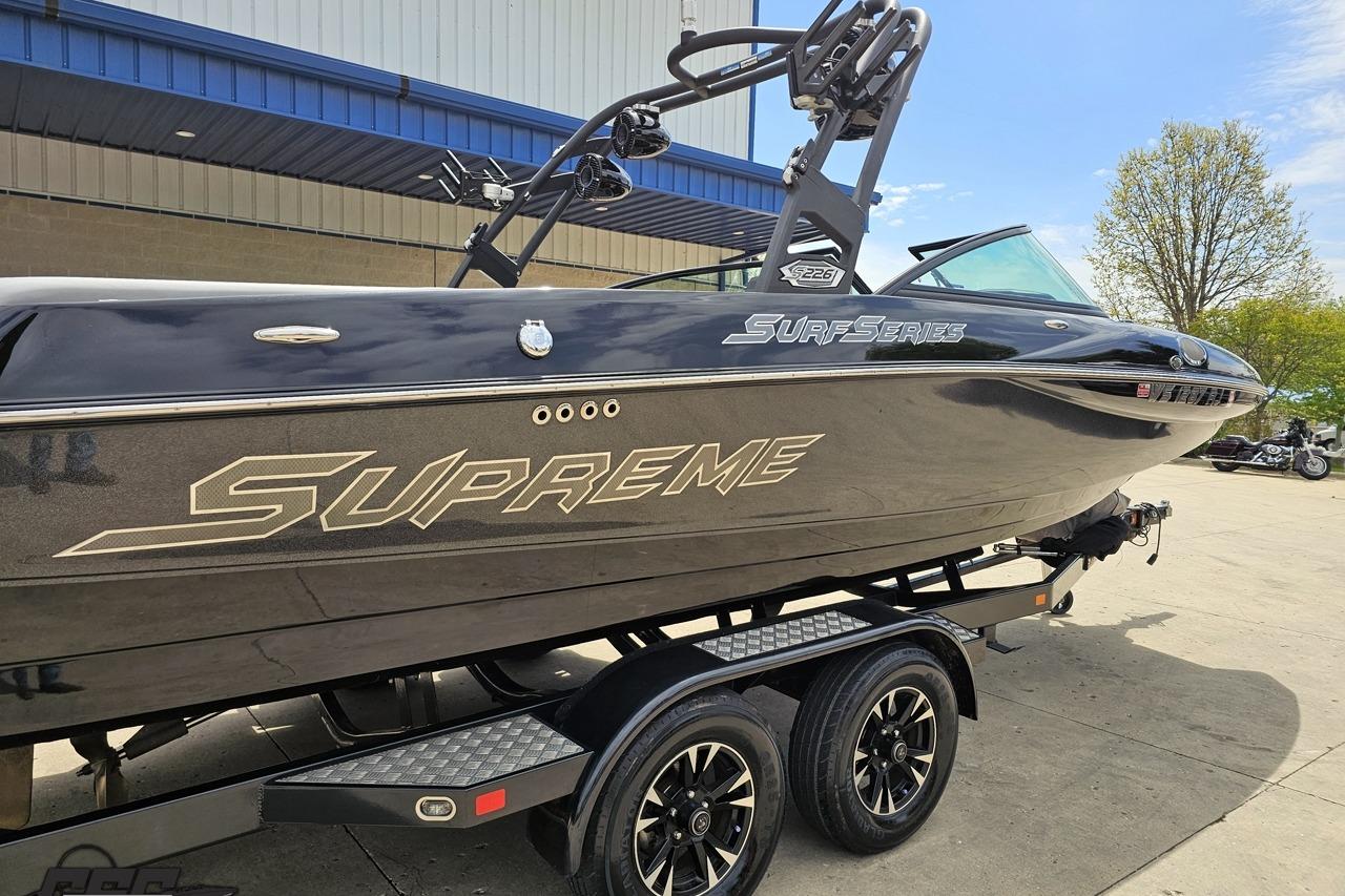 2018 Supreme S226 boat on trailer, black exterior, parked outdoors.