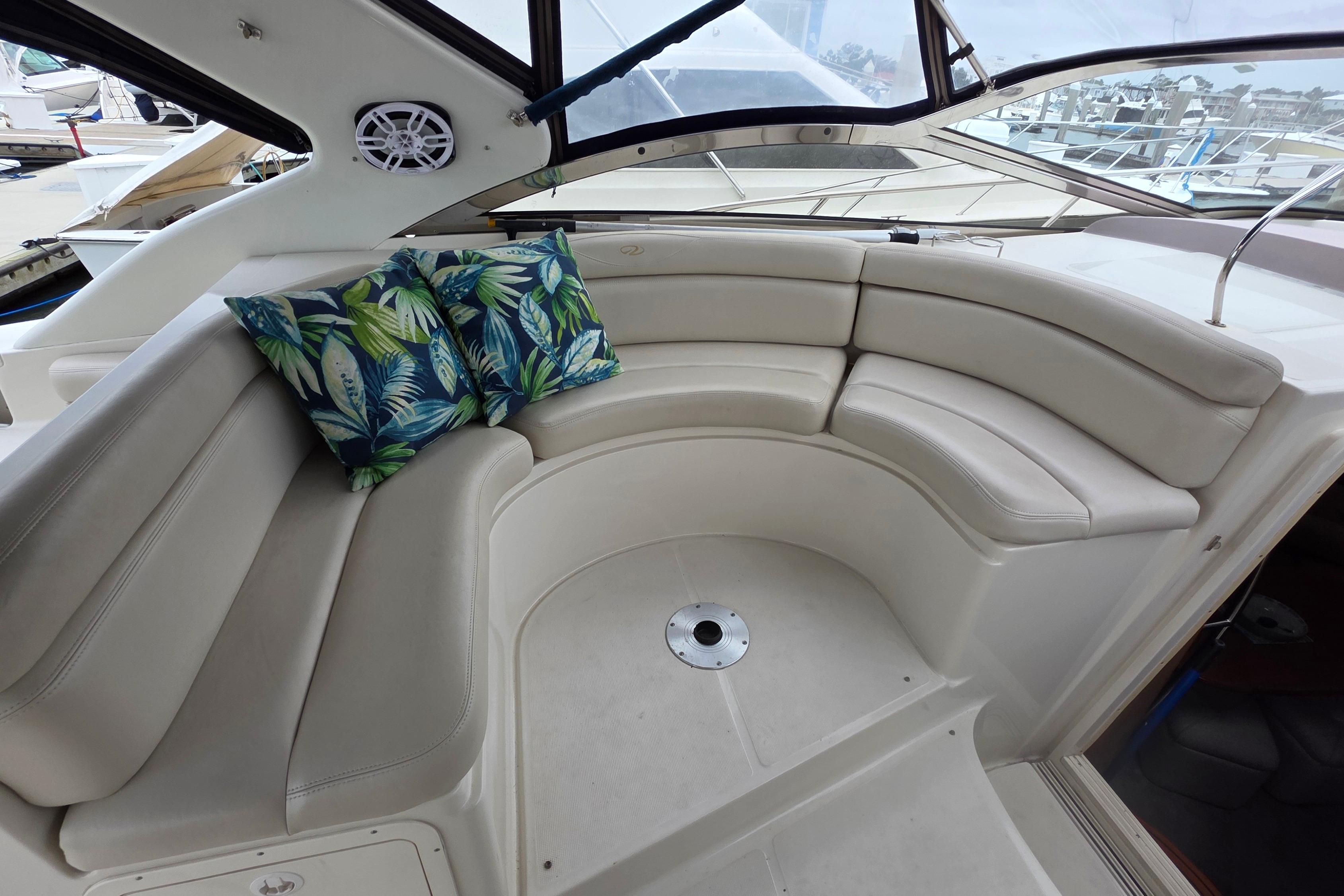 Luxurious seating area on 2002 Regal Commodore 4260 yacht with tropical cushions.