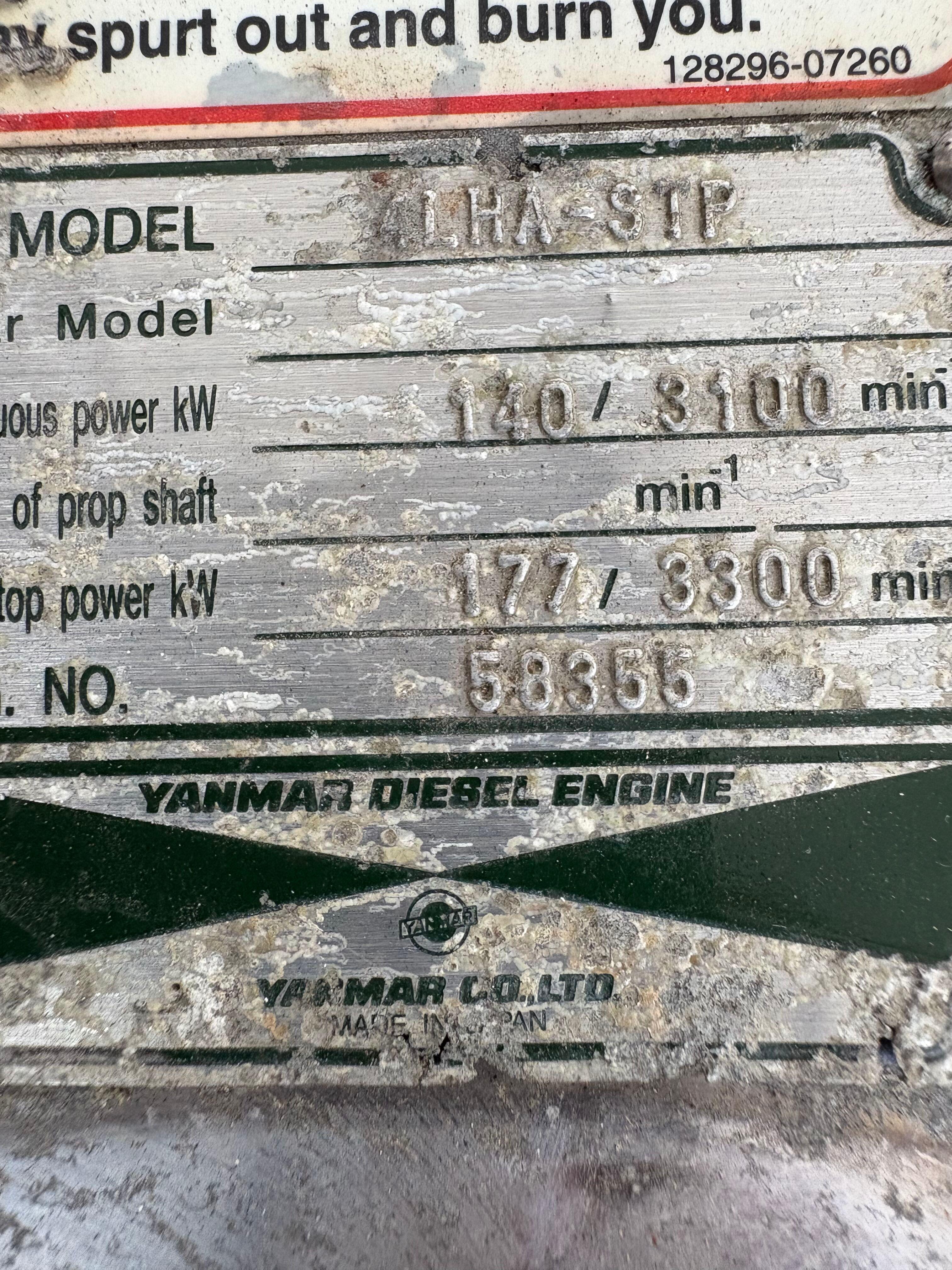 Close-up of a Yanmar diesel engine plate with specifications and serial number.
