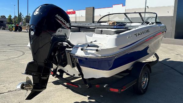 2024 Tahoe 200 S boat with Mercury outboard motor in a parking lot.