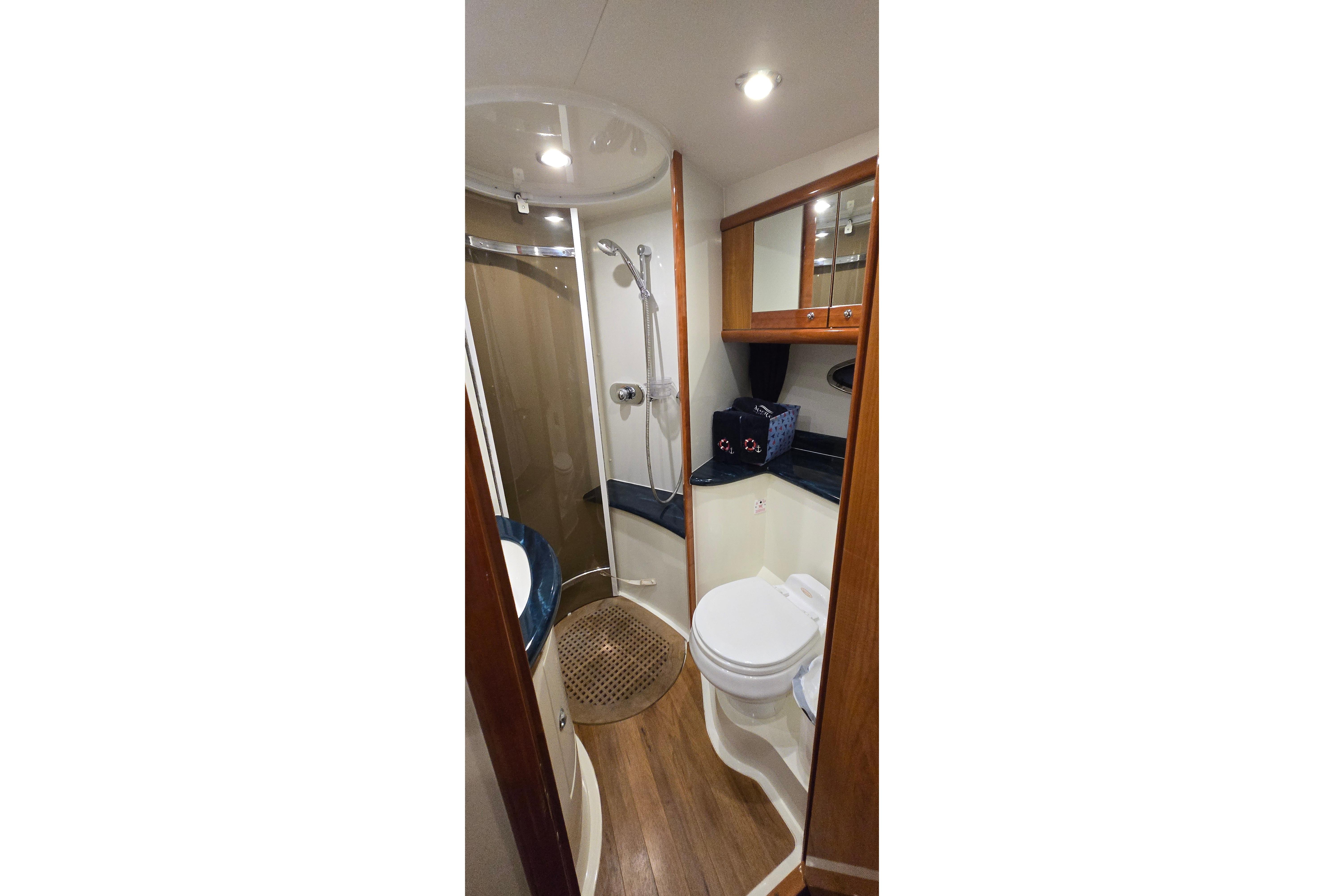 Bathroom interior of 2004 Sunseeker Camargue 50 yacht, featuring shower and wooden accents.
