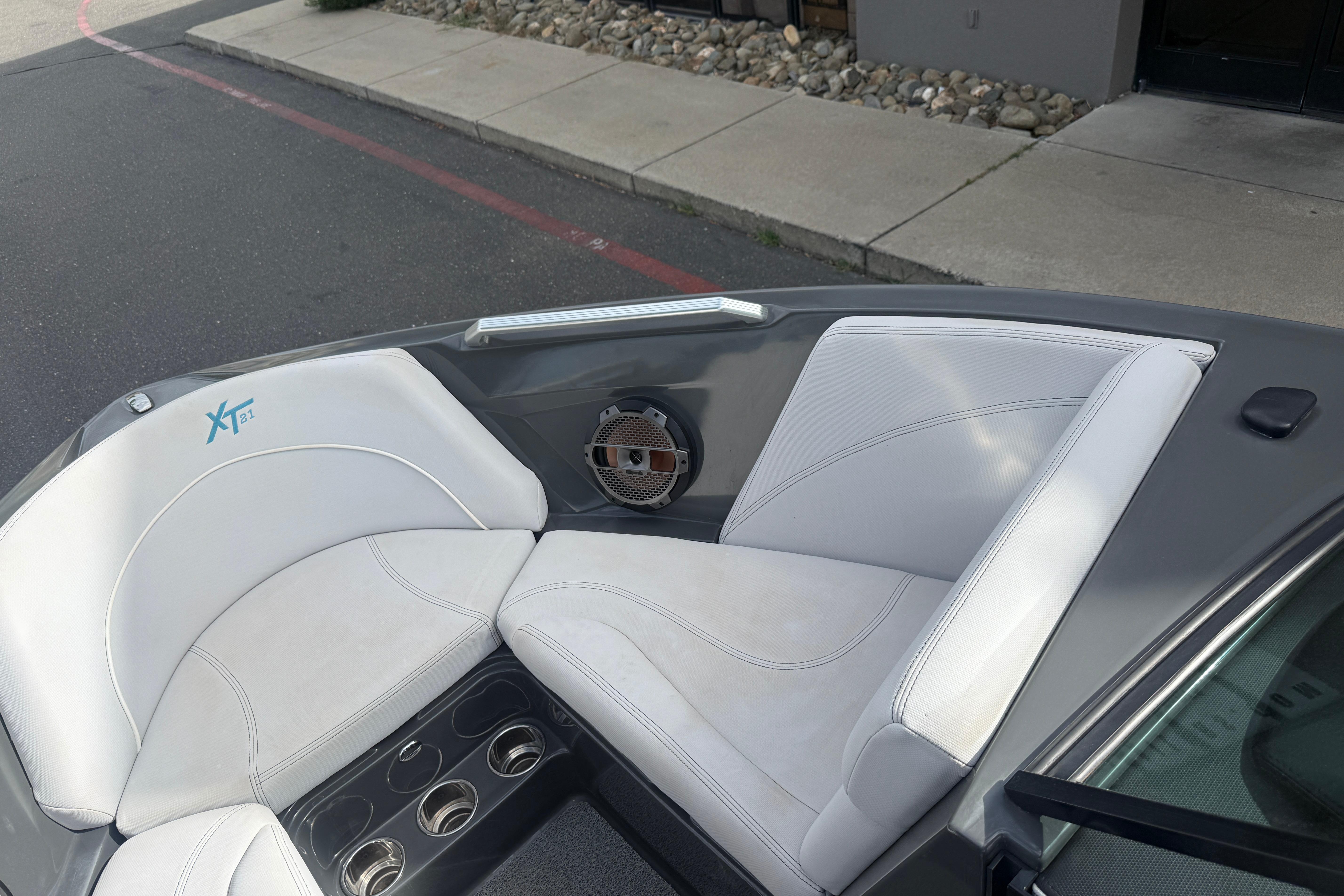 2018 MasterCraft XT21 boat interior with white seating and speaker detail.