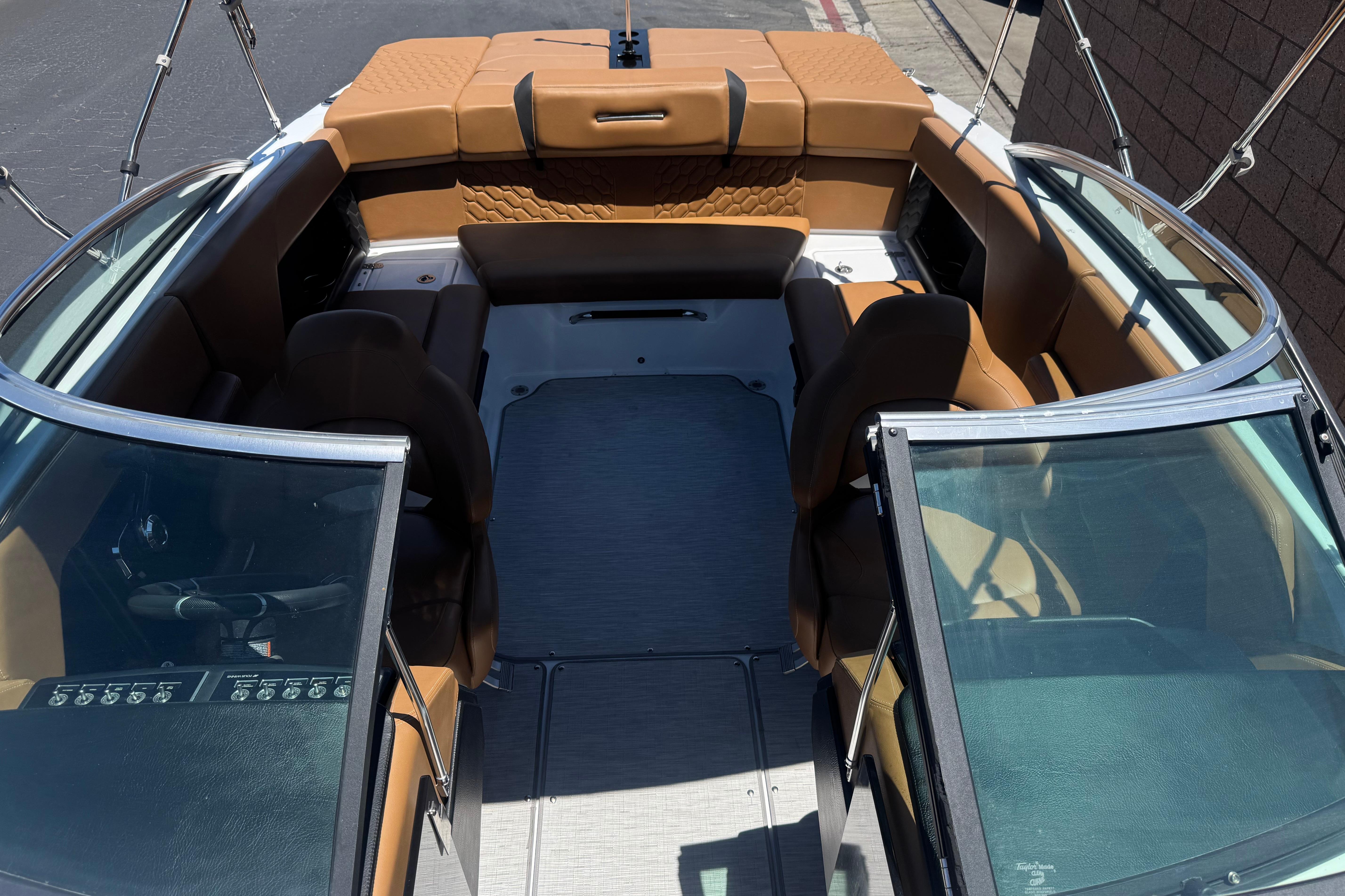 Interior view of 2022 Four Winns H4 boat with tan seating and open windshield.