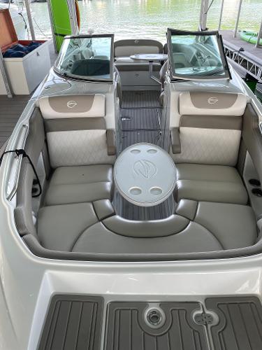2019 Crownline E255 boat interior with seating and table, docked by the water.