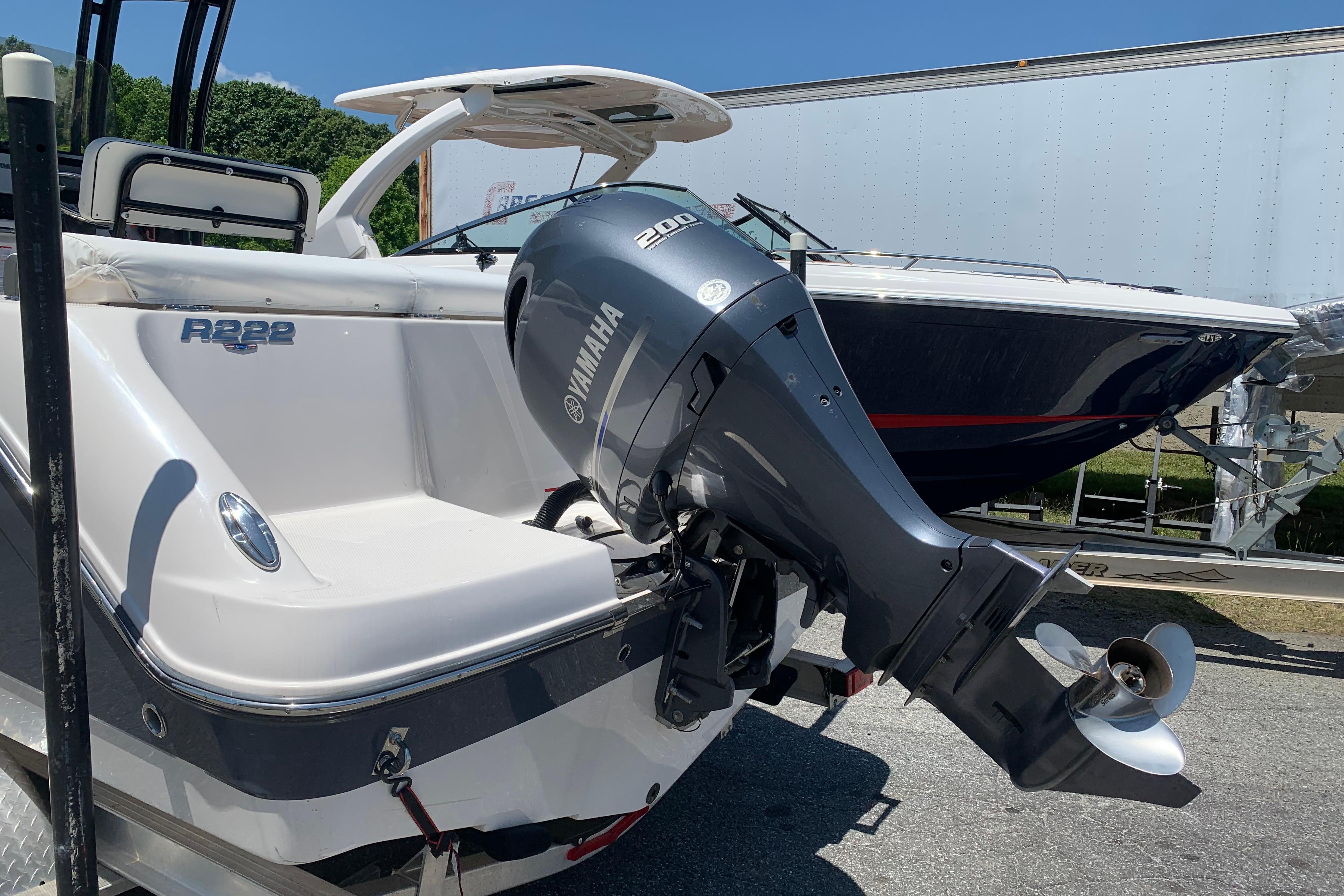 2023 Robalo R222 Center Console boat with Yamaha 200 engine, parked outdoors.