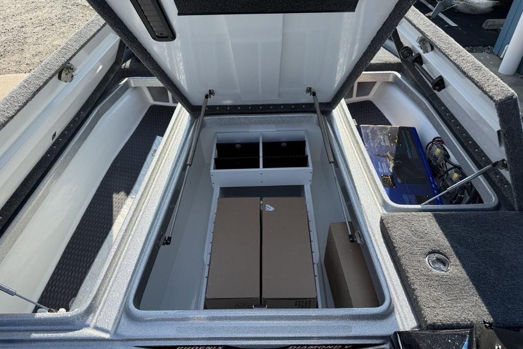 2026 Phoenix 20 XE boat storage compartments with open lids and visible battery setup.