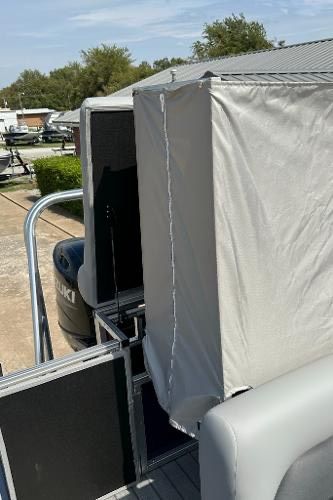 2024 Landau ATLANTIS 230C boat with covered seating area.