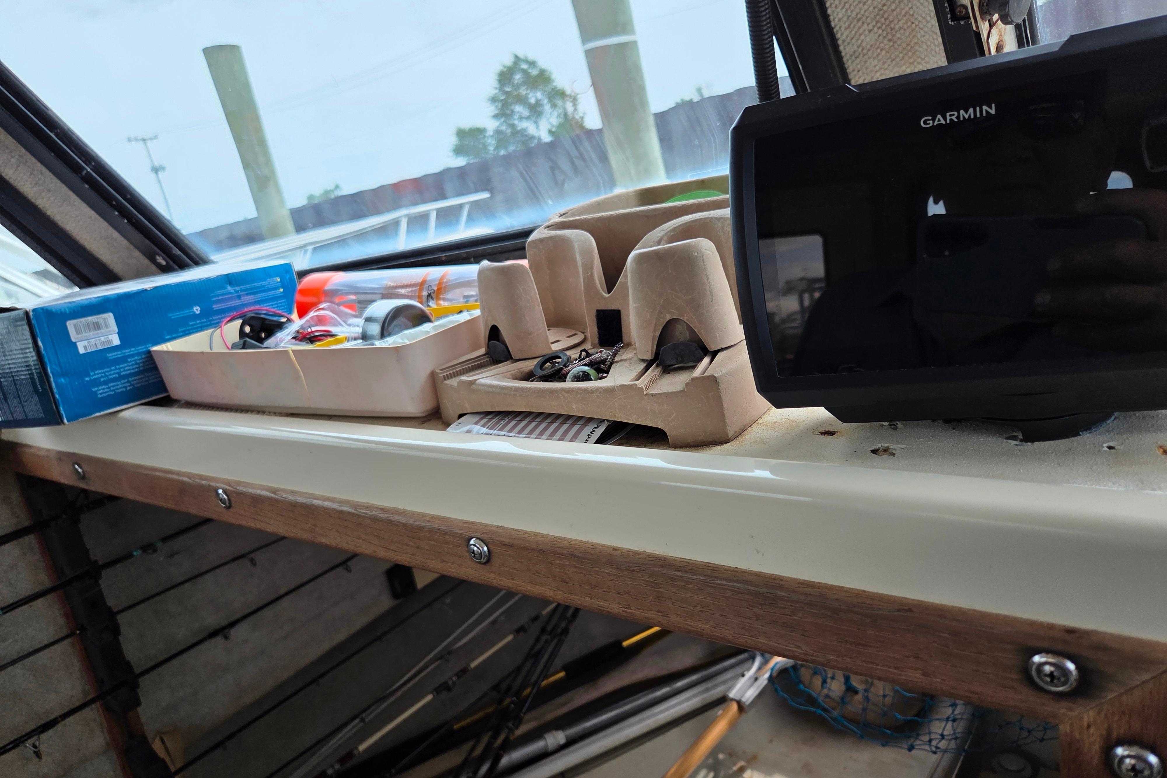 Interior of a 2002 Parker 2520 Deep Vee Sport Cabin with Garmin device and fishing gear.