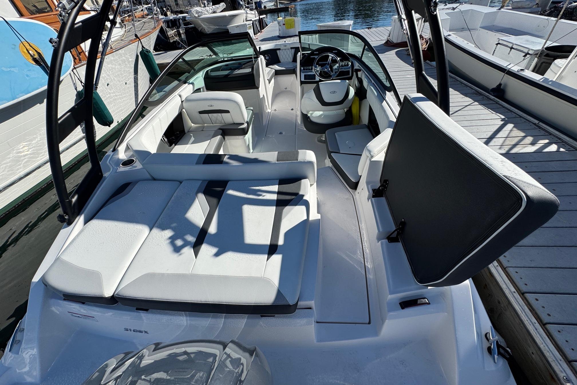 2026 Regal 21 OBX boat interior with seating and steering wheel at a marina.
