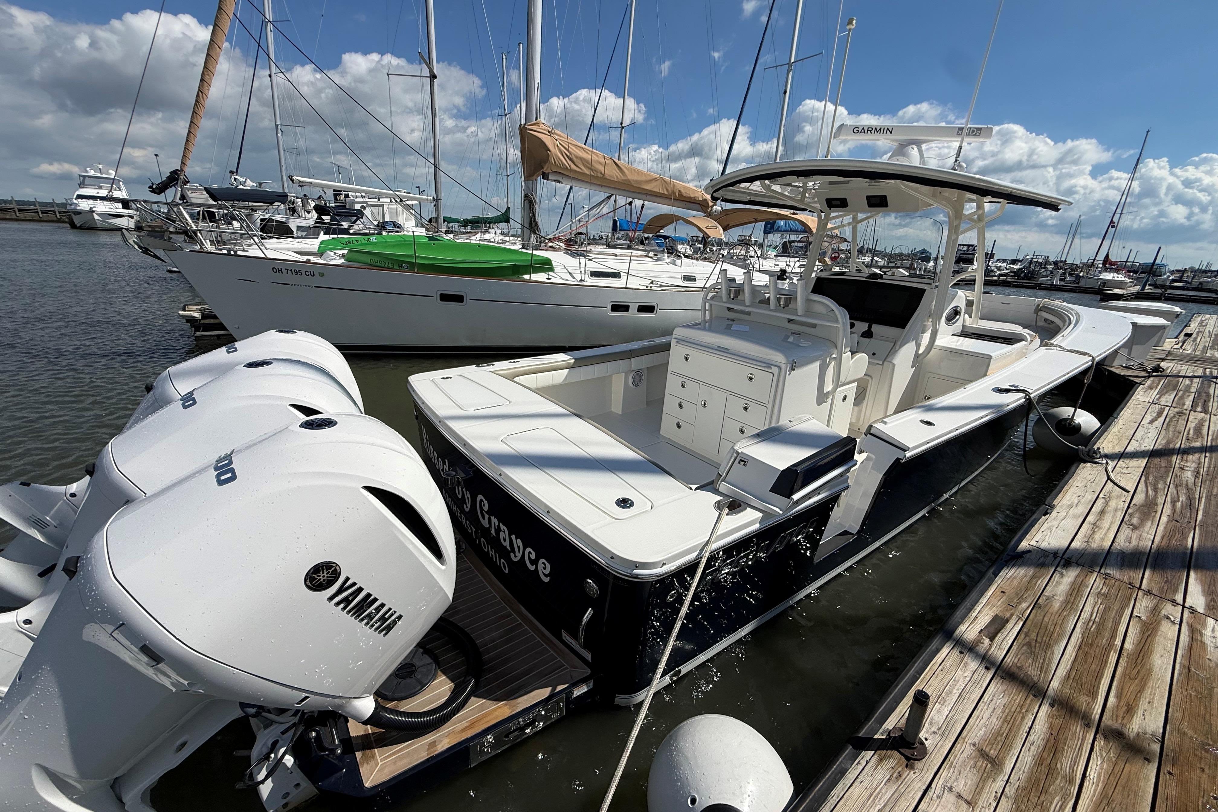 2019 Regulator 34SS boat docked with Yamaha engines, surrounded by sailboats.