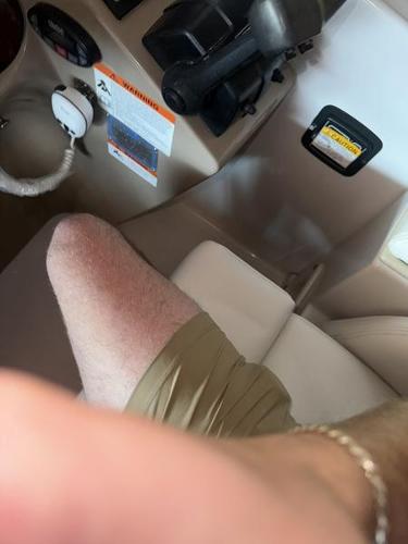 Interior of a 2005 Four Winns 298 Vista boat cockpit with controls and seating.
