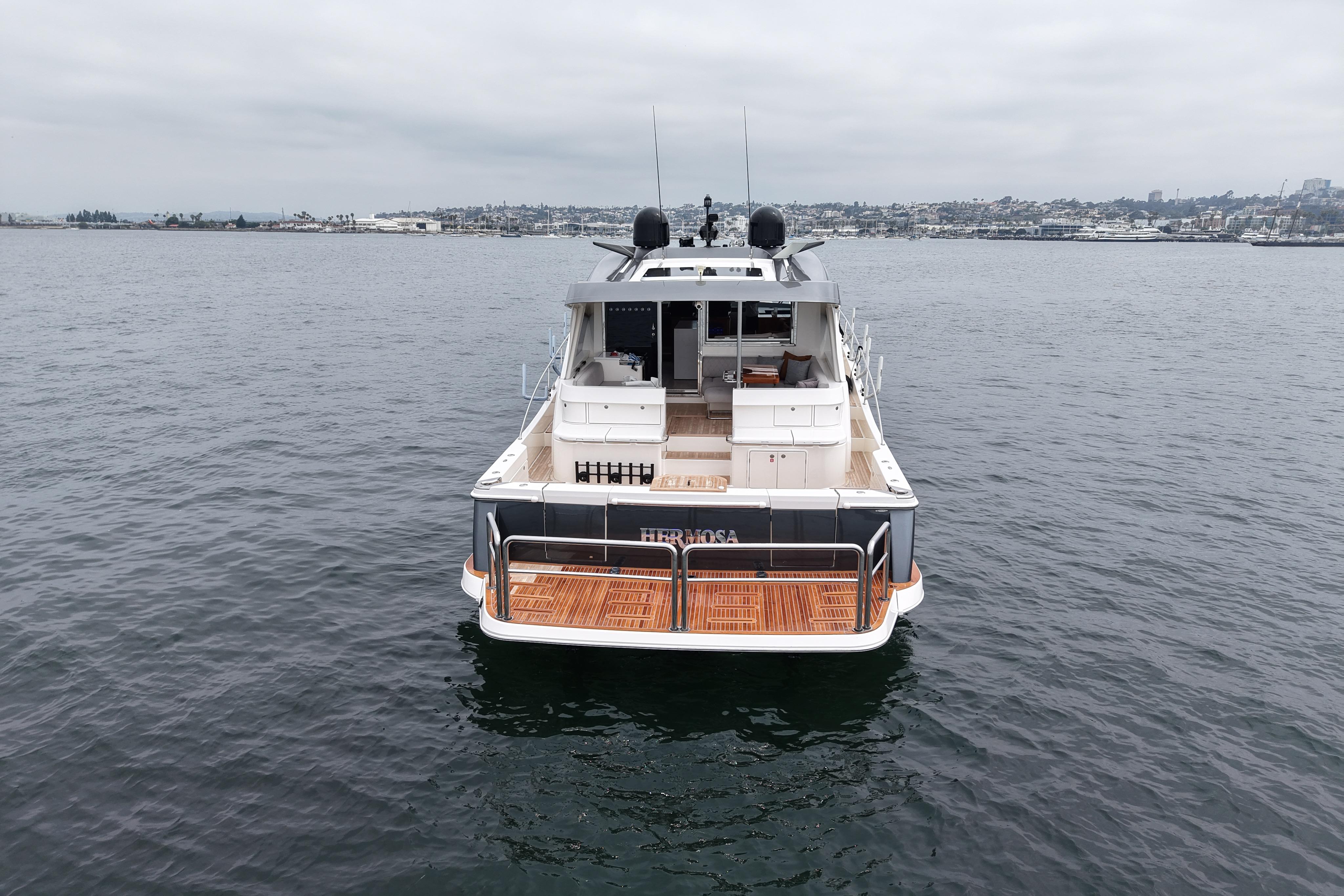2023 Riviera 645 SUV yacht on calm waters, showcasing spacious deck and sleek design.
