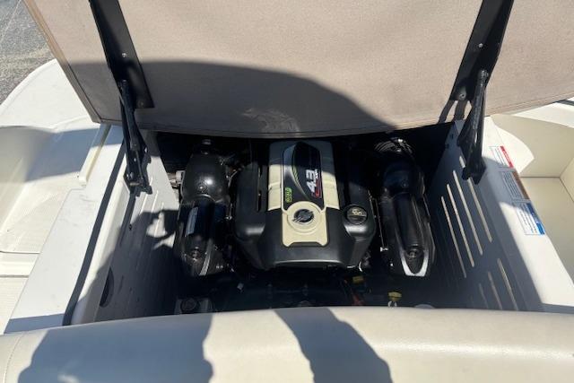 Engine compartment of a 2012 Sea Ray 210 SLX boat, showcasing the engine details.