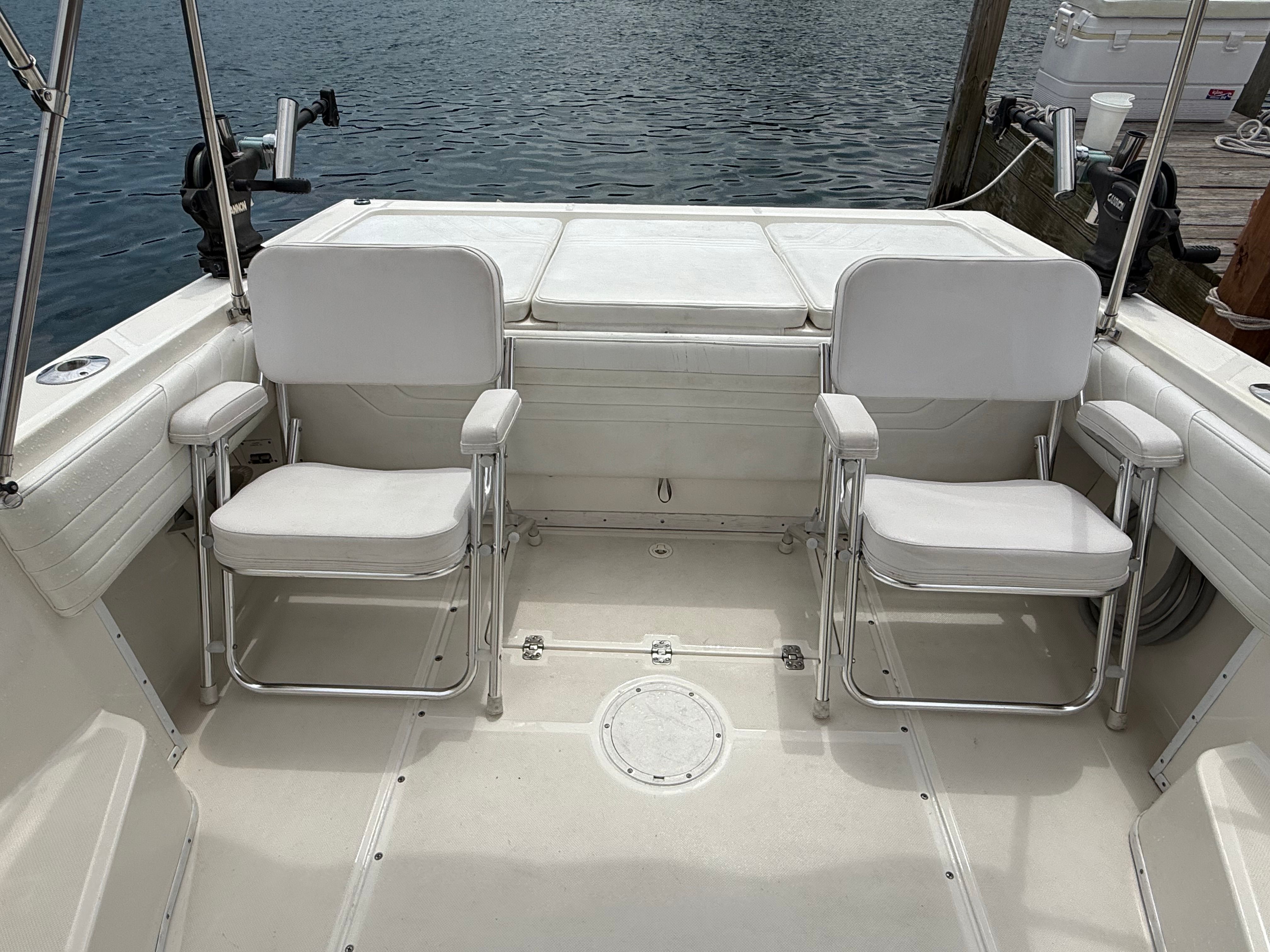 Interior of a 1999 Fountain 32 Sport Fish Cruiser with white seating.