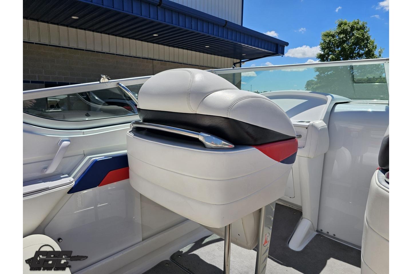 2005 Formula 271 FASTech boat interior with white and red seating under blue sky.