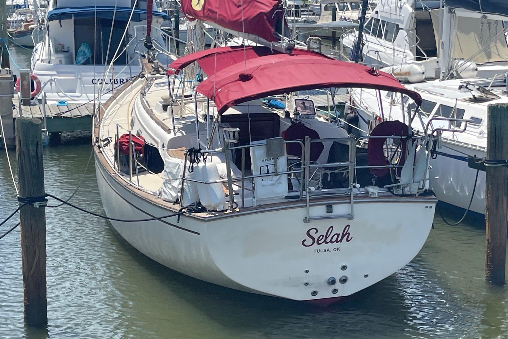 1989 Island Packet 35 sailboat named "Selah" docked in a marina.