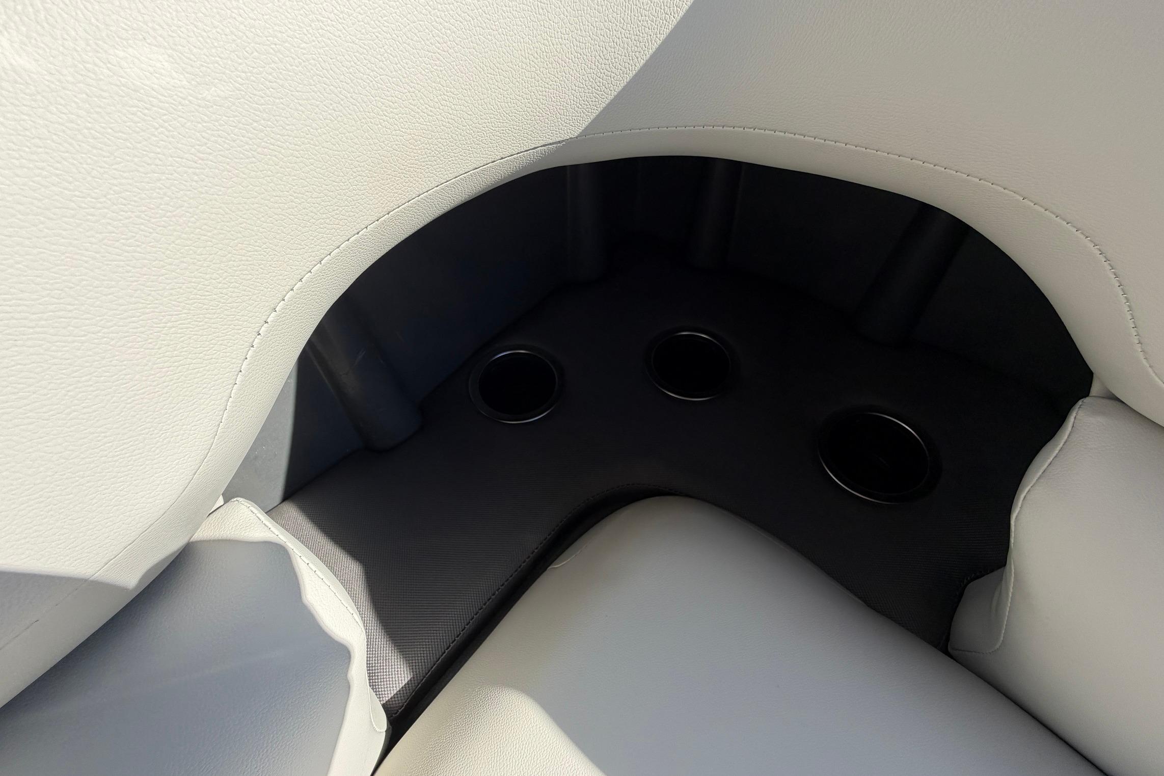 Interior seating with cup holders on 2026 Sun Tracker Fishin' Barge 22 XP3.