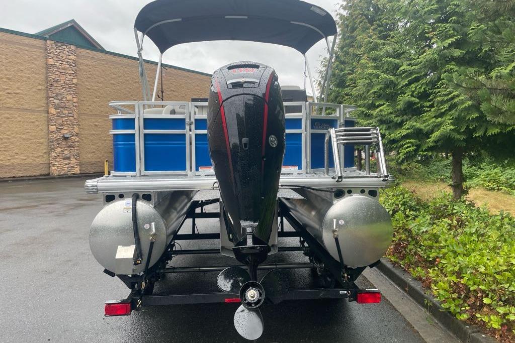 2026 Sun Tracker Fishin' Barge 20 DLX pontoon boat, rear view with motor and ladder.