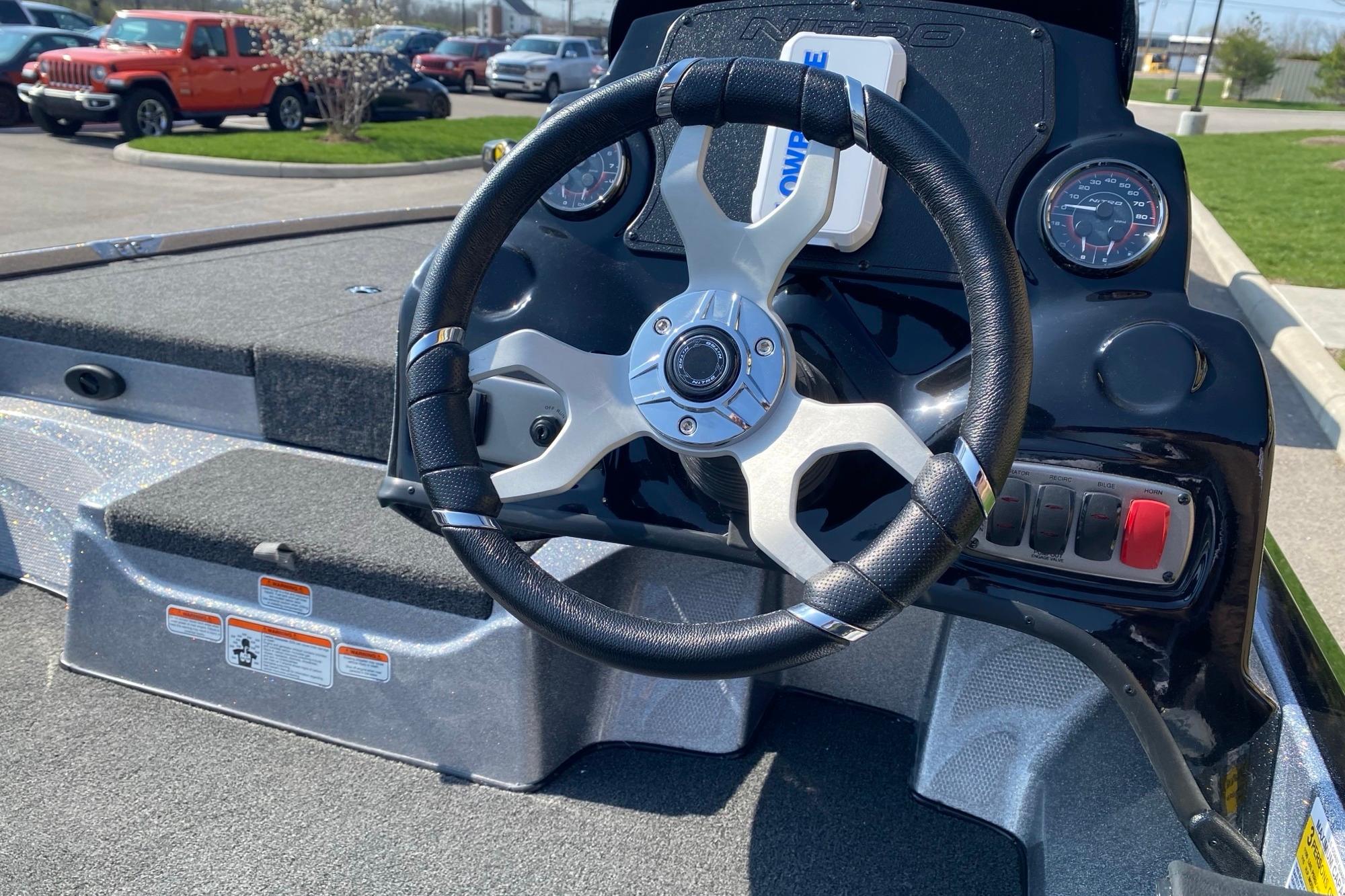Steering wheel of a 2026 Nitro Z17 boat, featuring modern dashboard controls.