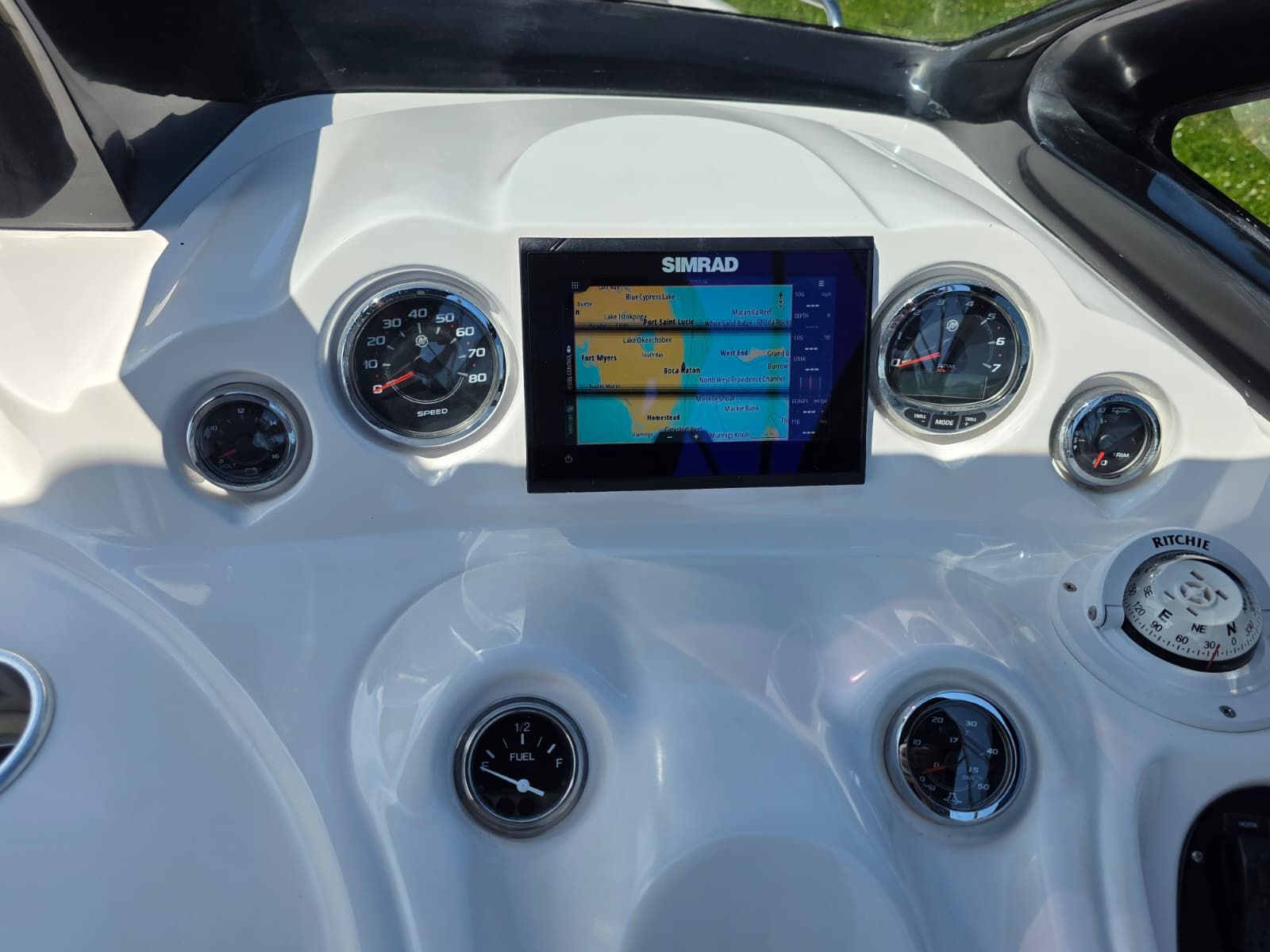 The dashboard of a Coral 26 boat with a Simrad display and various gauges.