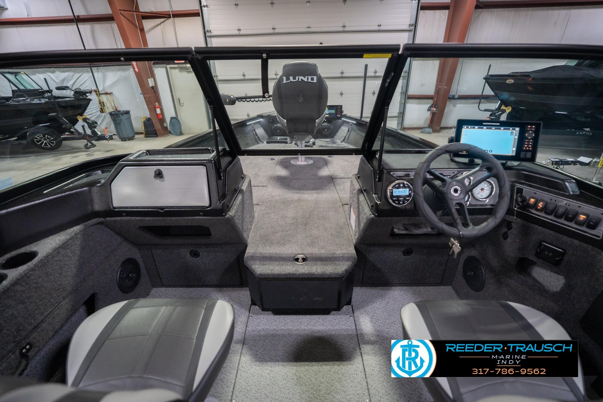 2026 Lund 2075 Impact XS boat interior with steering wheel and dashboard controls.