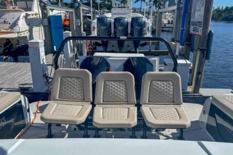 2023 BRABUS Shadow 900 ST boat with beige seating at a marina dock.