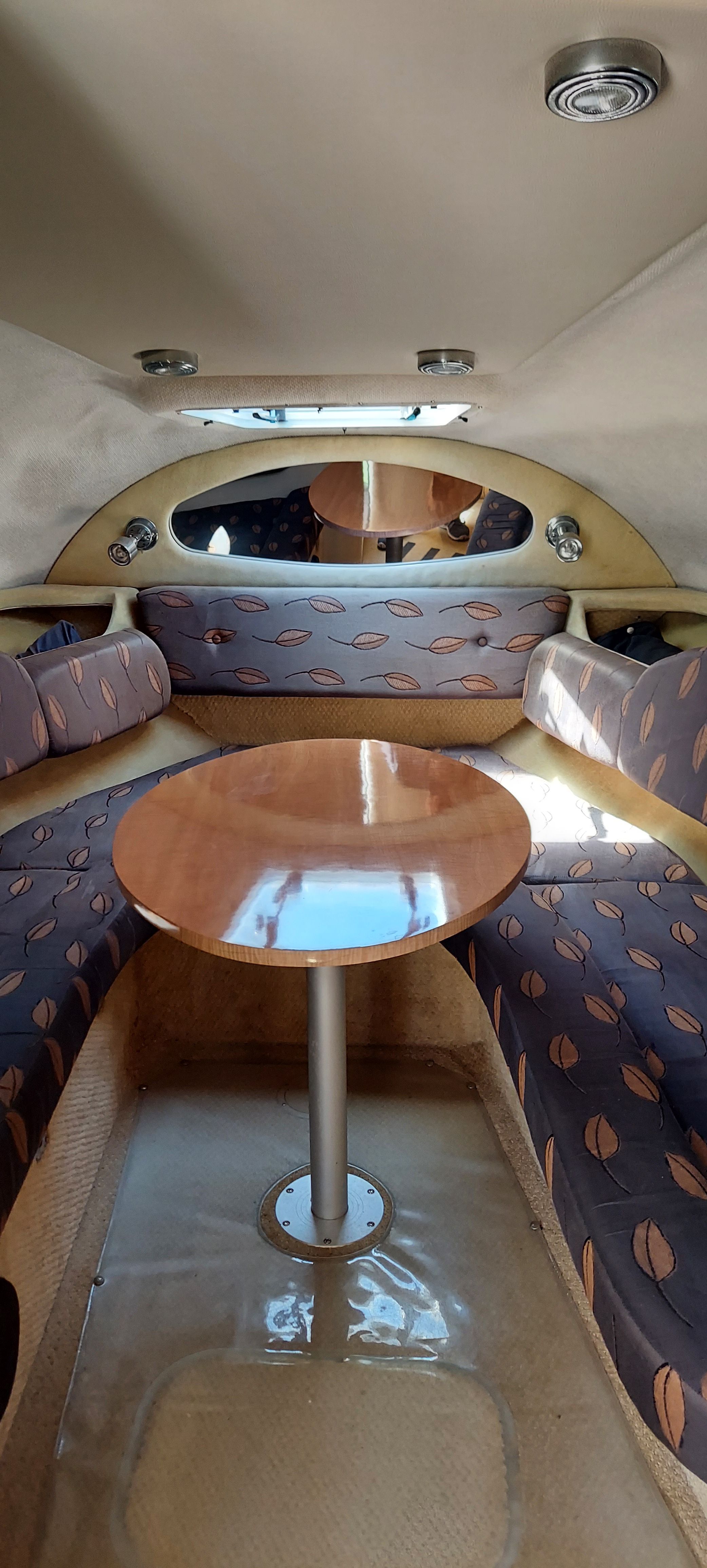 Interior of a 2004 Regal Commodore 2465 with table and seating.