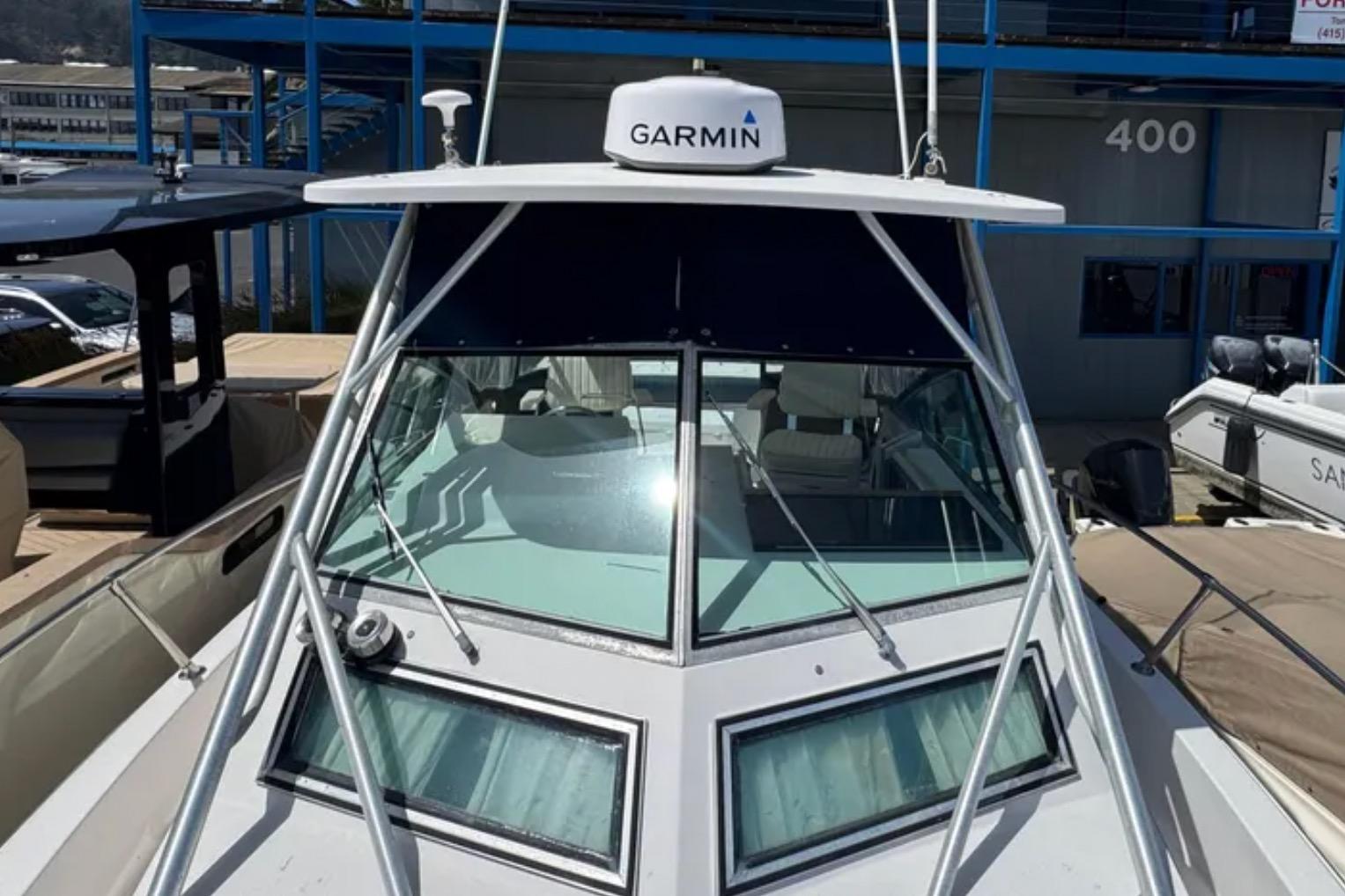 1990 Grady-White Marlin 280 boat with Garmin equipment, docked at a marina.