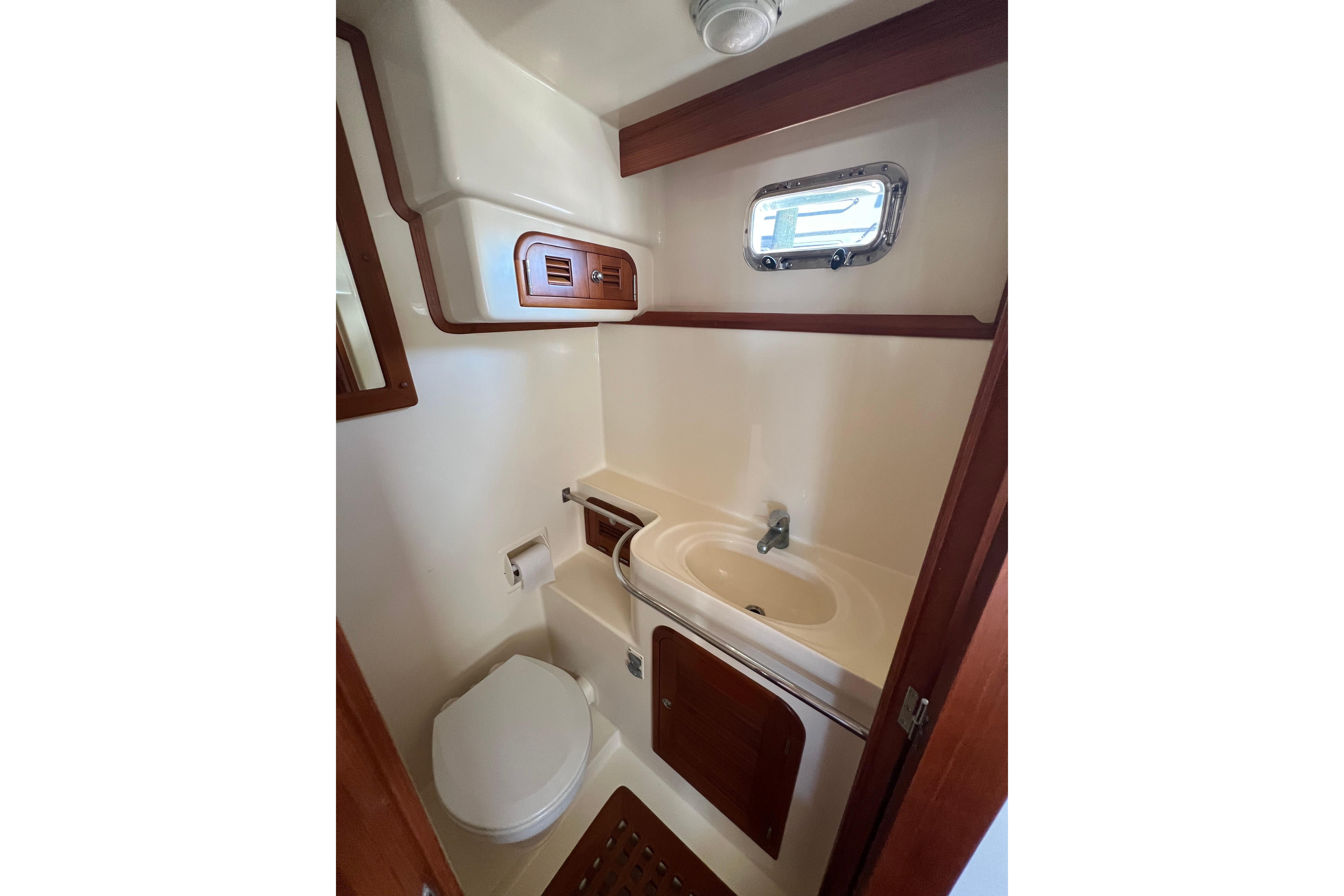 Bathroom interior of 2007 Heritage East 36 Sundeck Trawler with sink and toilet.
