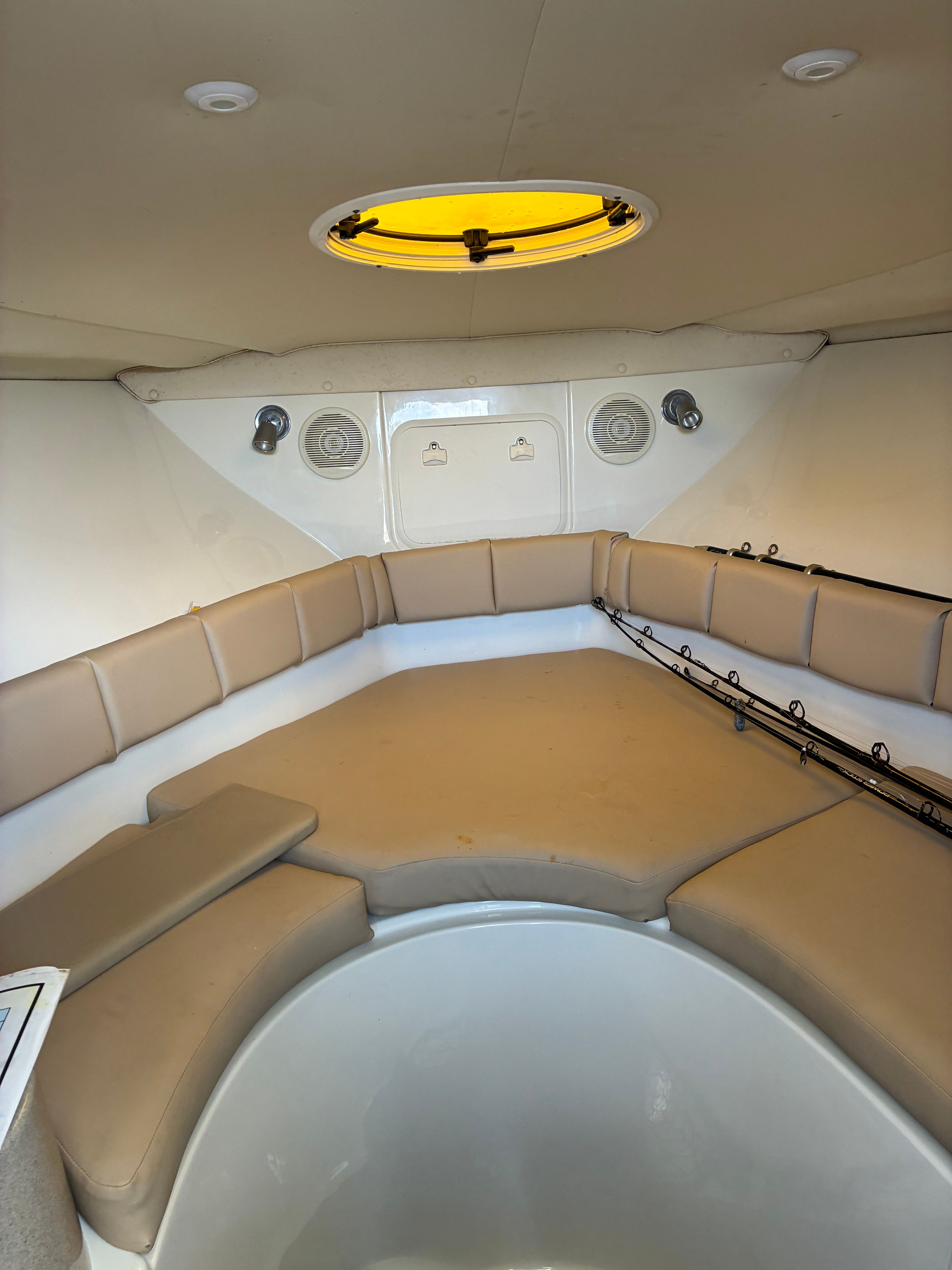 Interior of a 2023 Hydra-Sports Vector-VX with cushioned seating and fishing rods.