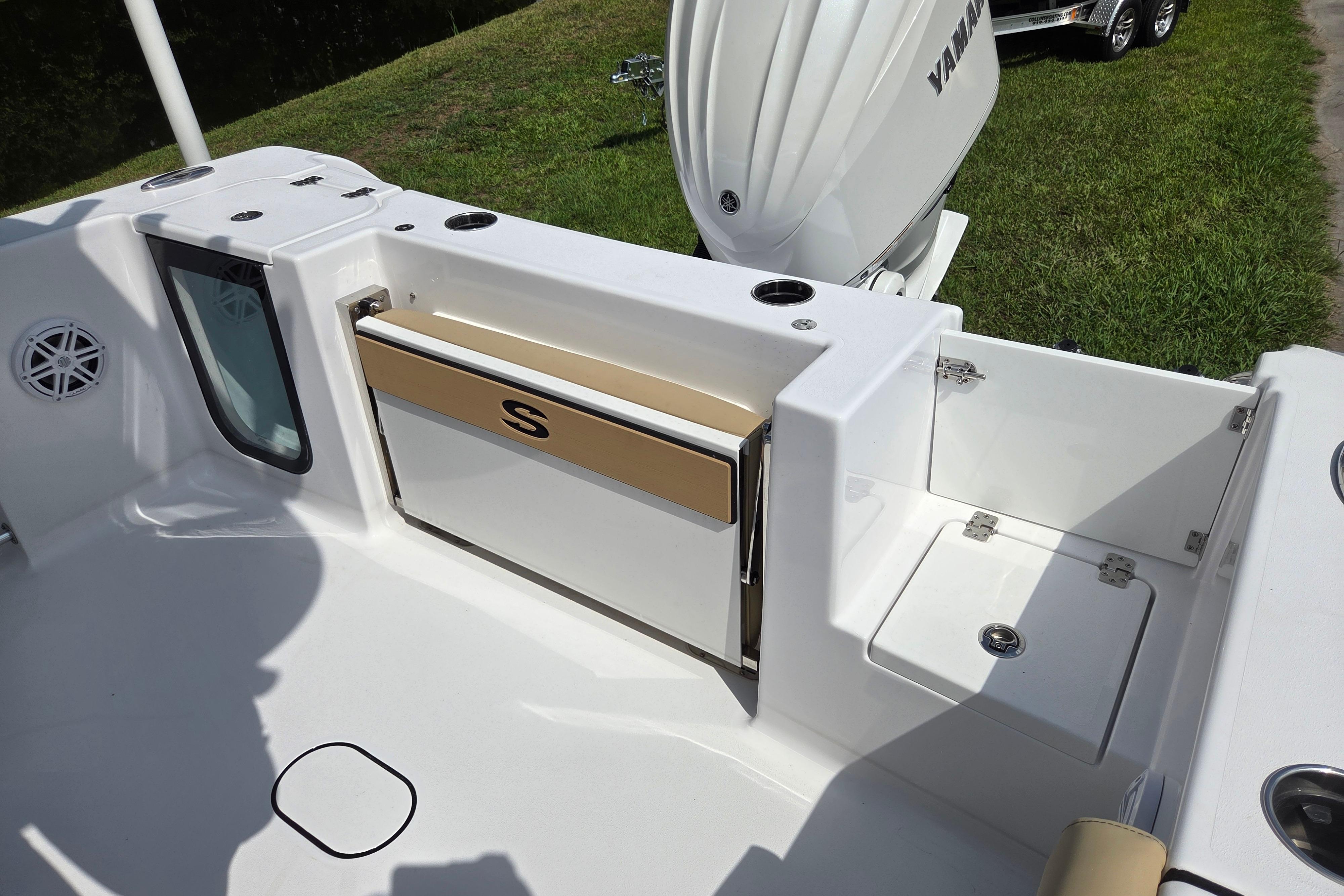 2026 Sportsman Open 232 Center Console boat interior with Yamaha engine, featuring storage and seating.