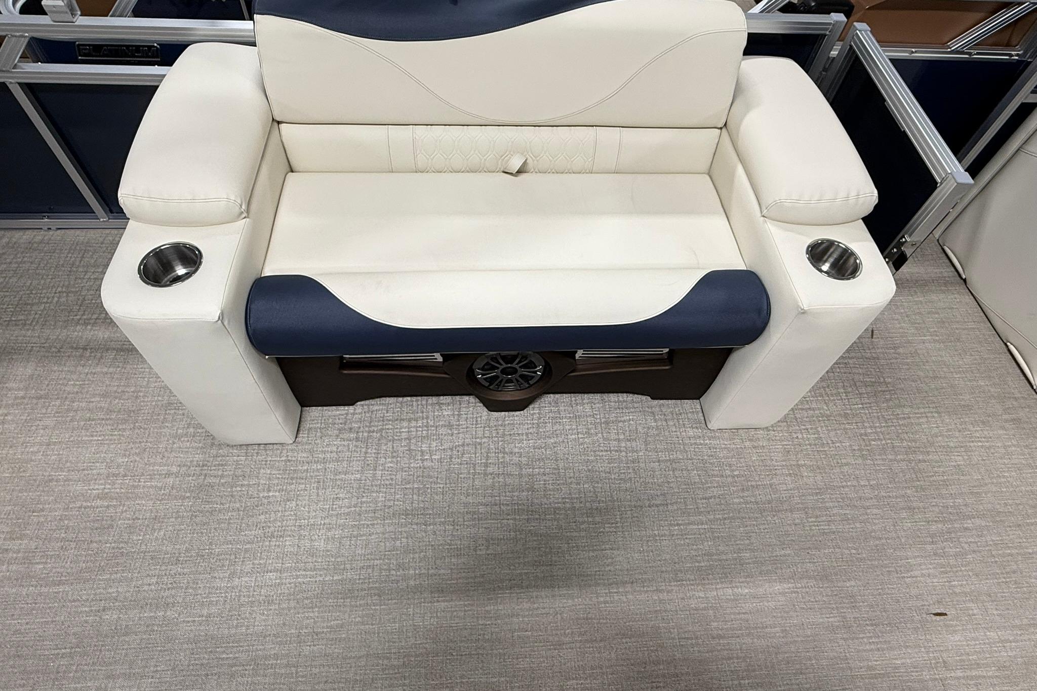 Luxurious seating on 2026 Avalon LSZ Elite 21' boat with cup holders and speaker.