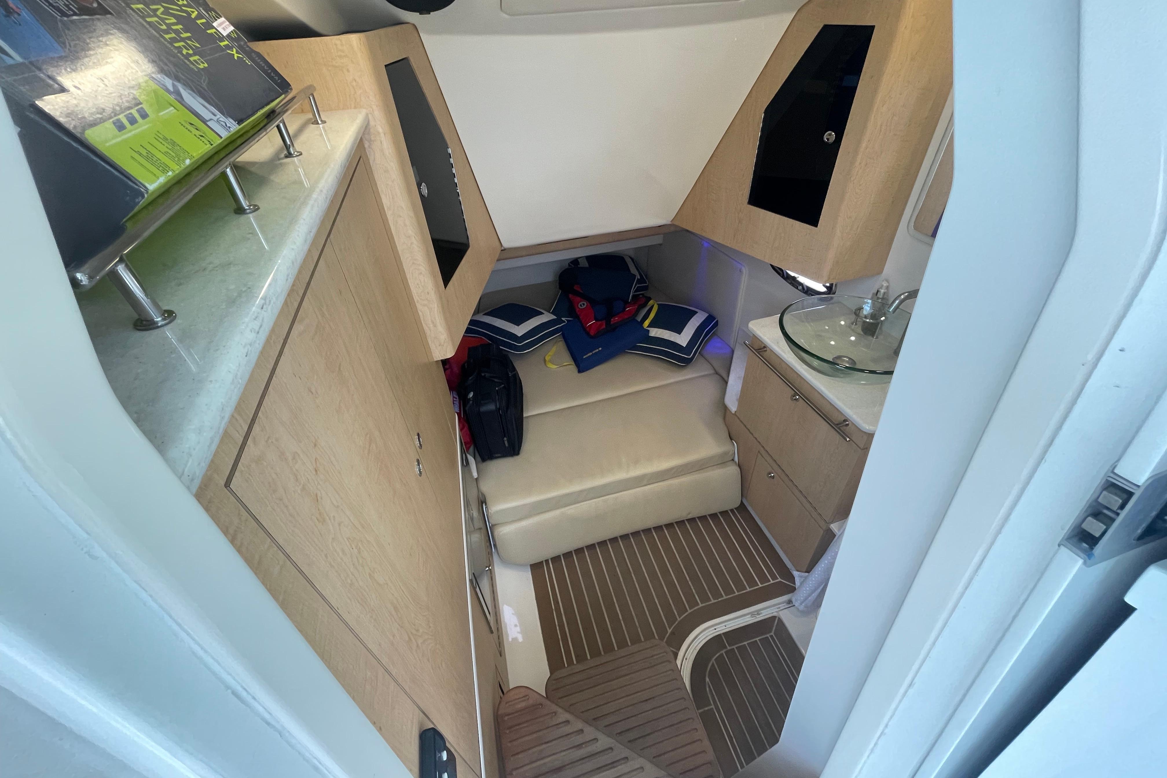 Interior cabin of 2015 Boston Whaler 370 Outrage, featuring seating and compact amenities.