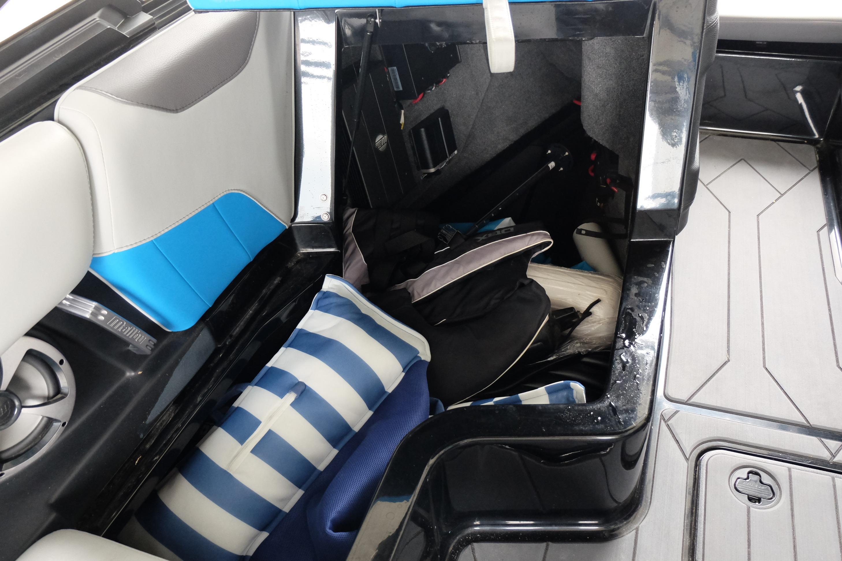 2020 Malibu Wakesetter 23 LSV interior storage with cushions and gear.