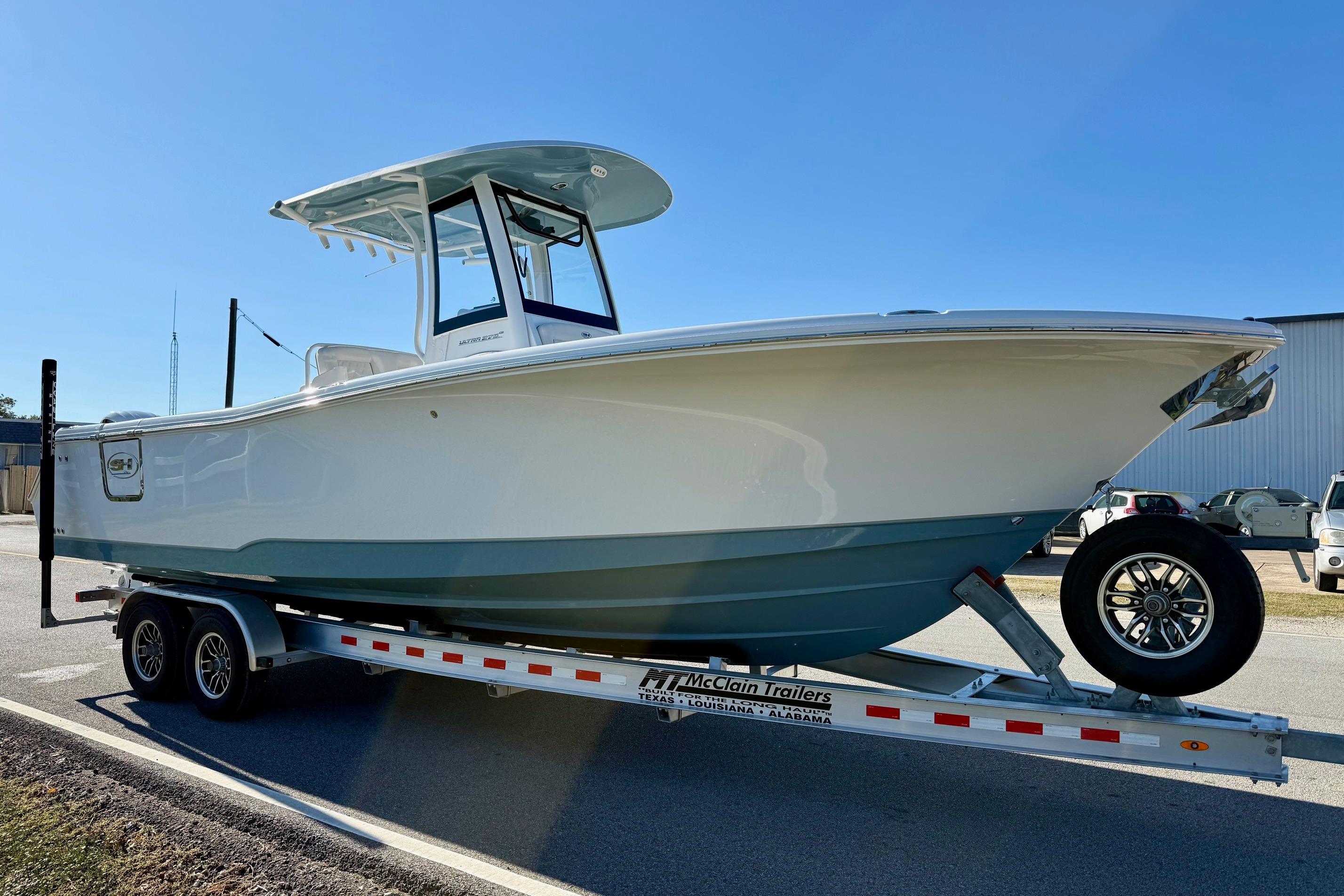 2026 Sea Hunt Ultra 275 Coffin Box boat on trailer, parked outdoors.