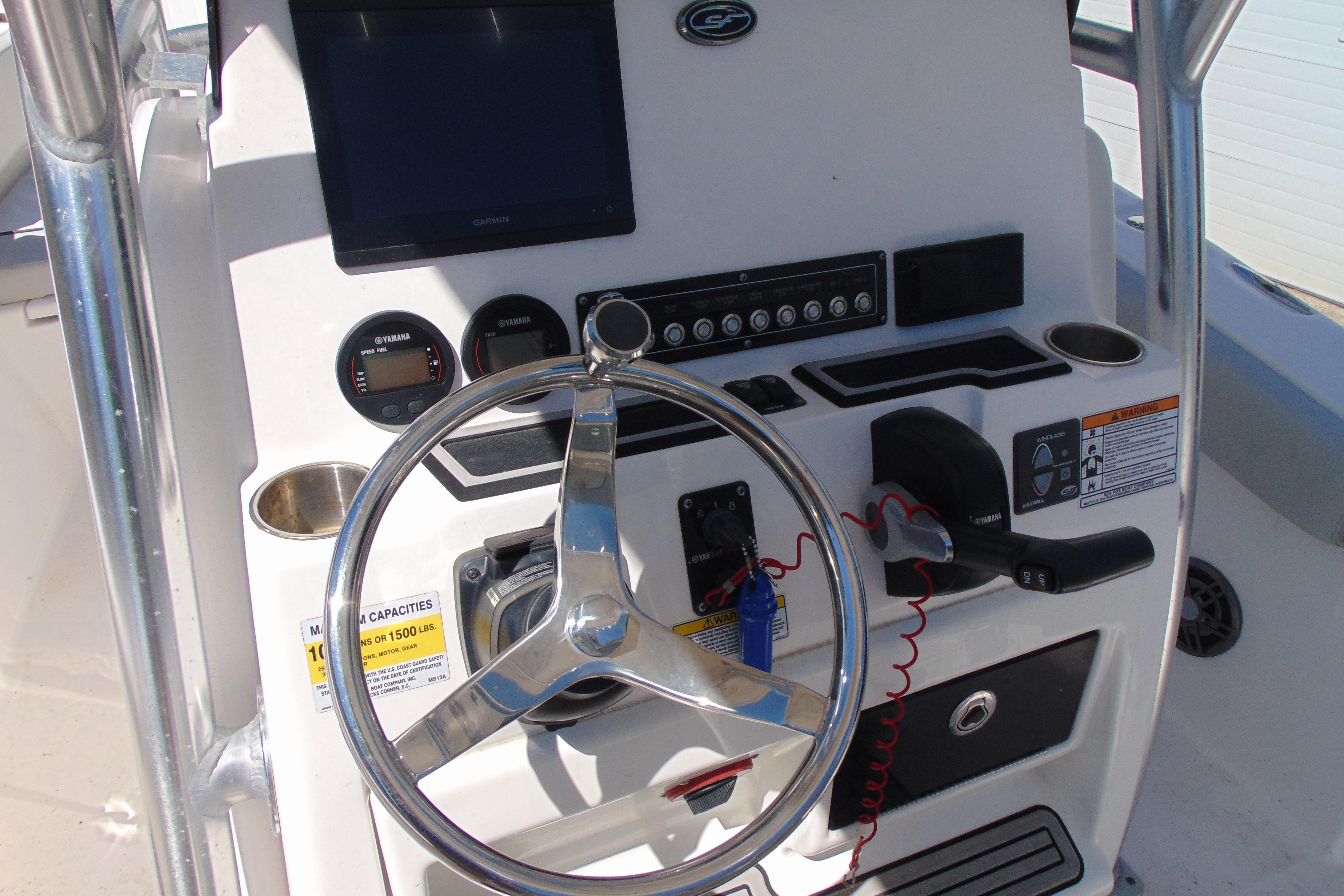 Steering console of 2022 Sea Fox 248 Commander boat with controls and gauges.