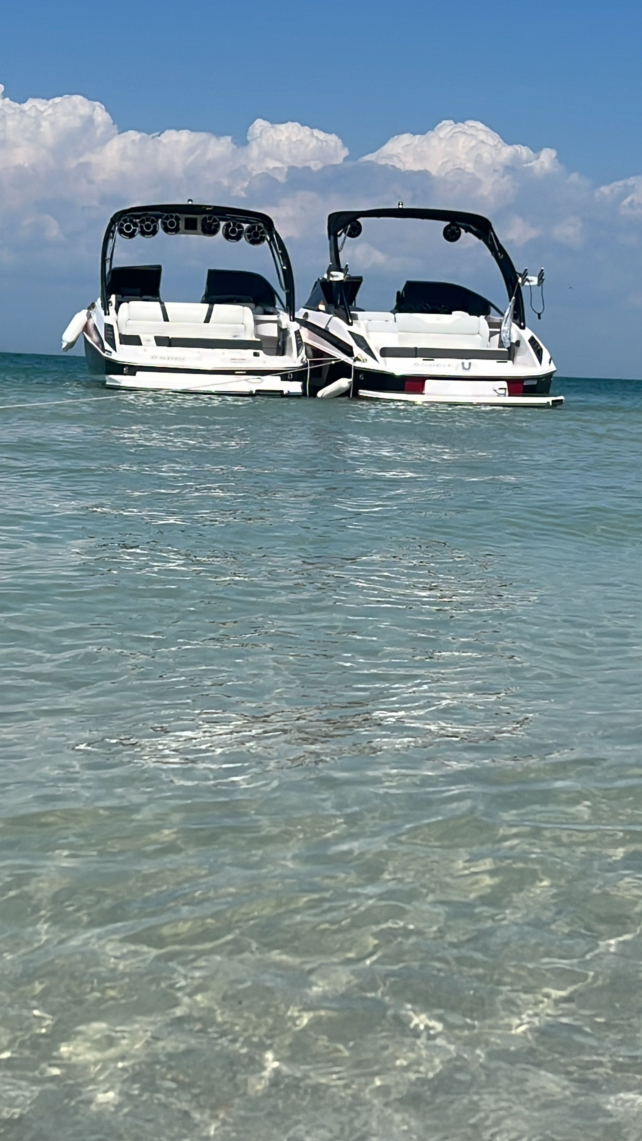 Two Regal 27 FasDeck boats in clear water, 2016 model.