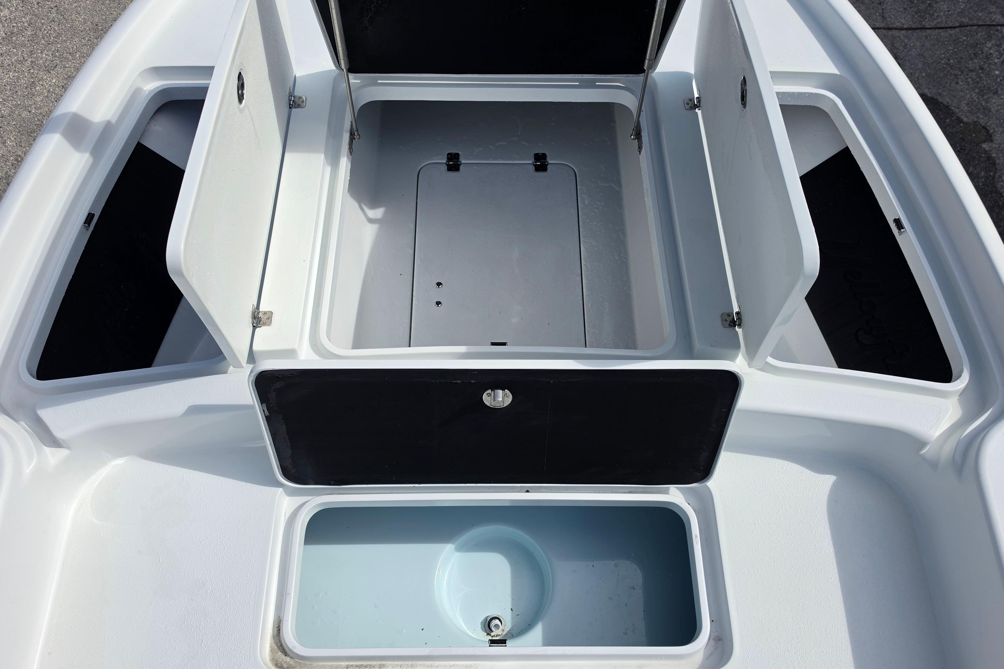 2026 Yellowfin 24 Bay CE boat storage compartments, open hatches, and livewell.