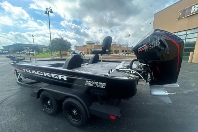 2026 Tracker Savage 215 boat with powerful outboard motor, parked outdoors.