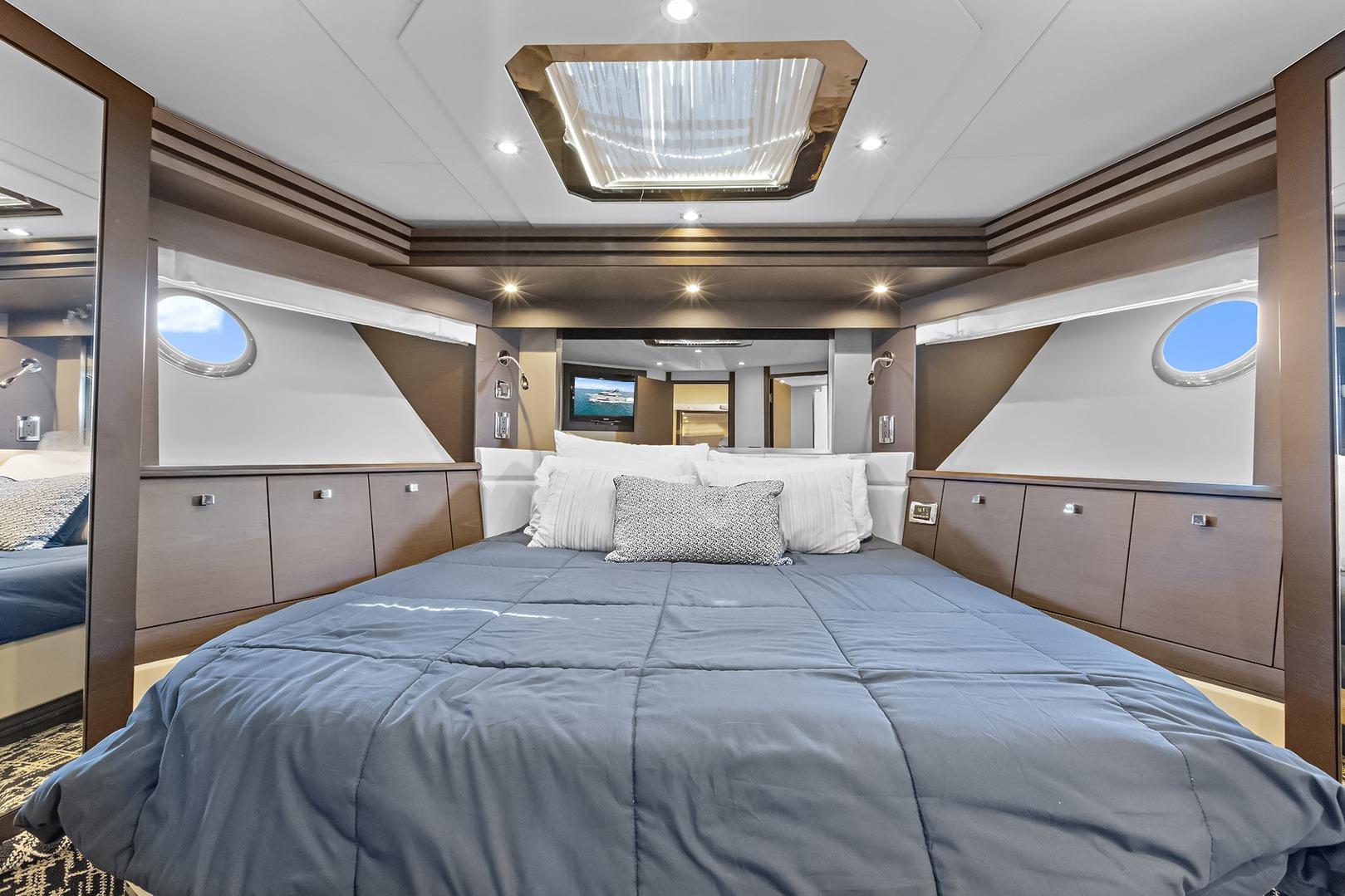 VIP bedroom interior of 2016 Marquis 720 Fly Bridge offers queen sized bed and private bathroom