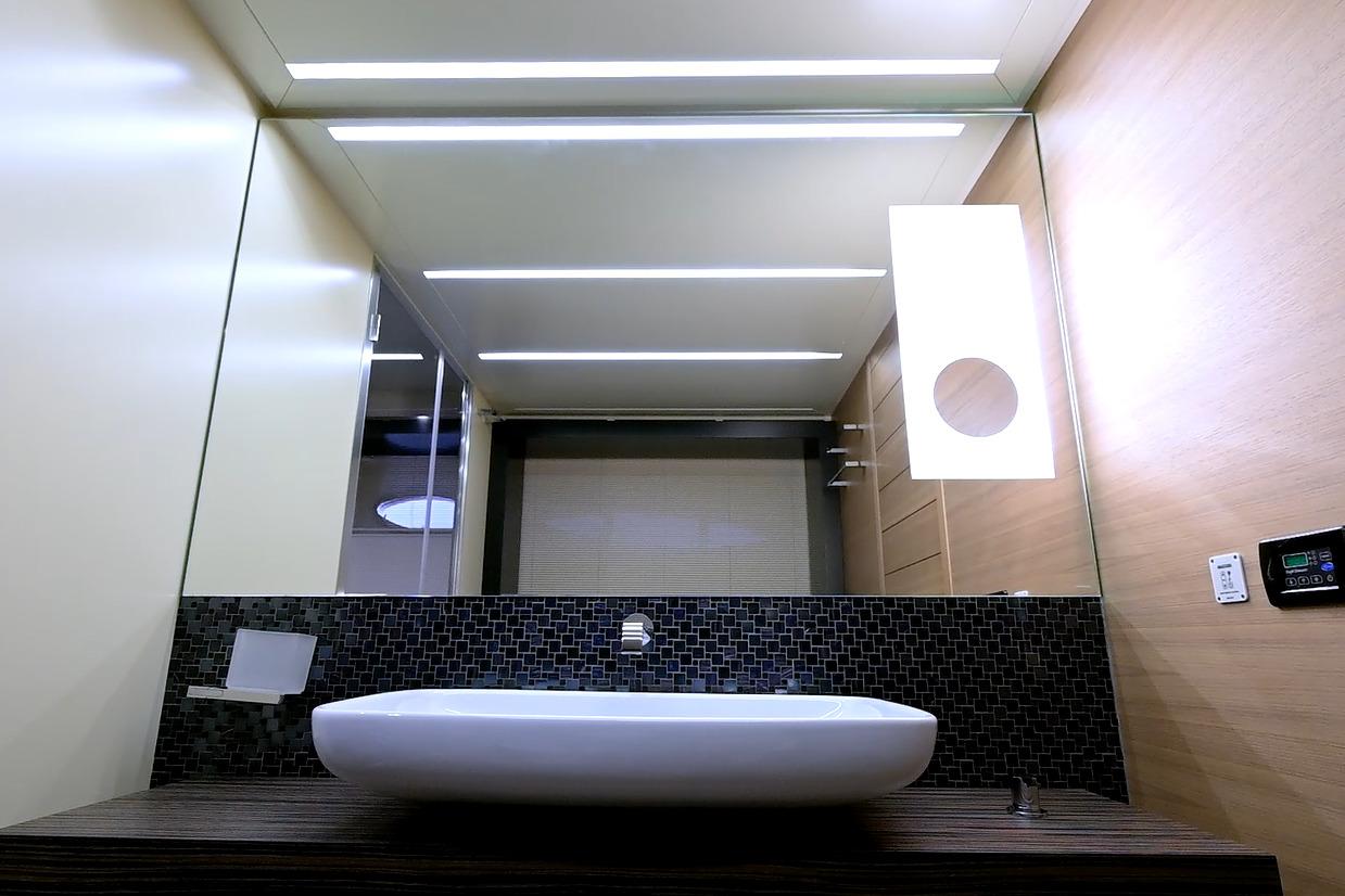 Modern bathroom interior on 2015 Pershing 92 yacht, featuring sleek sink and stylish lighting.