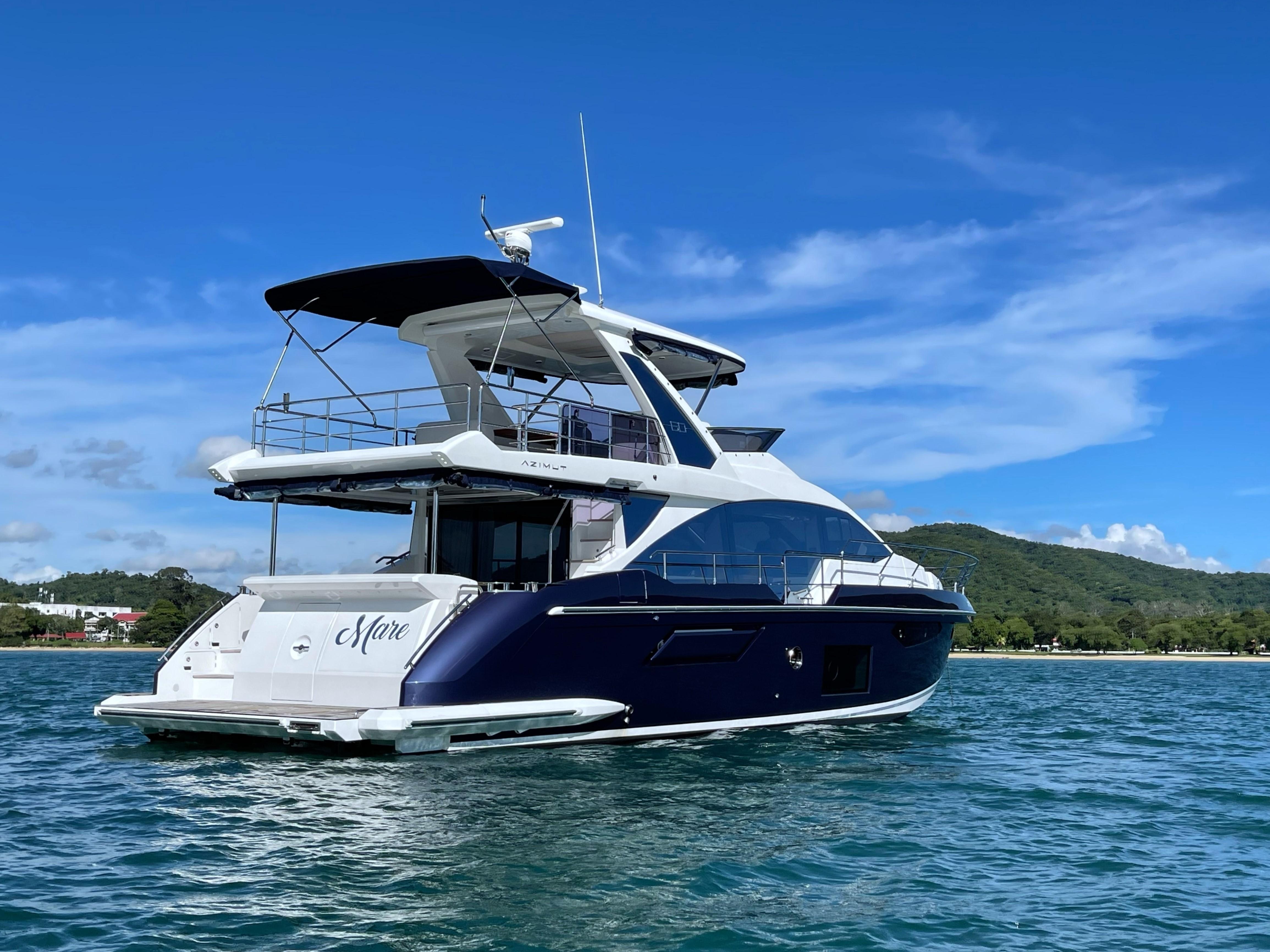 2020 Azimut 60 yacht on water, clear sky, scenic background.
