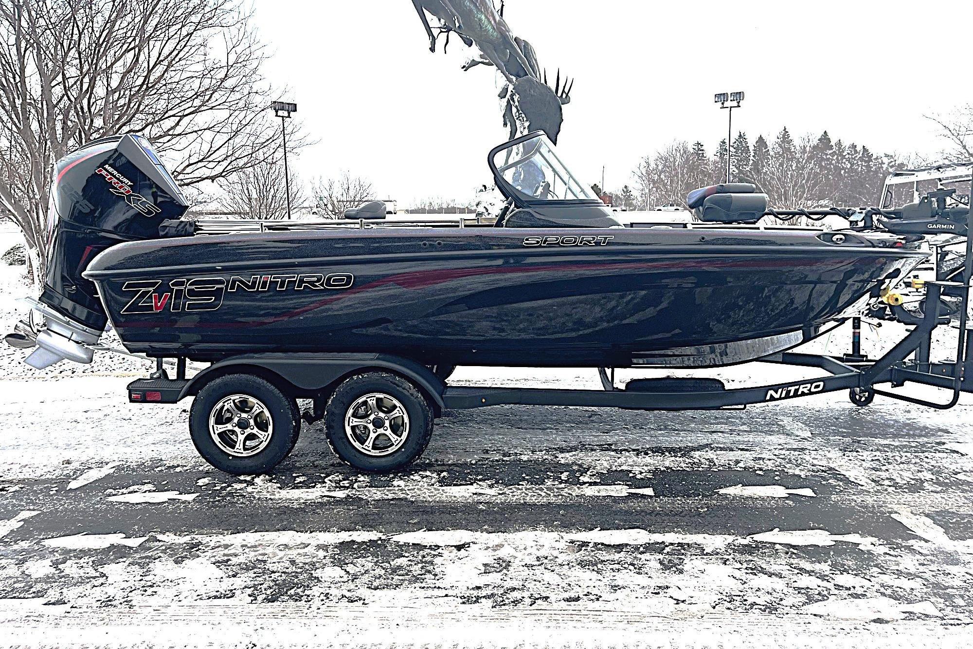 2026 Nitro ZV19 Sport Pro boat on snowy ground, side view.