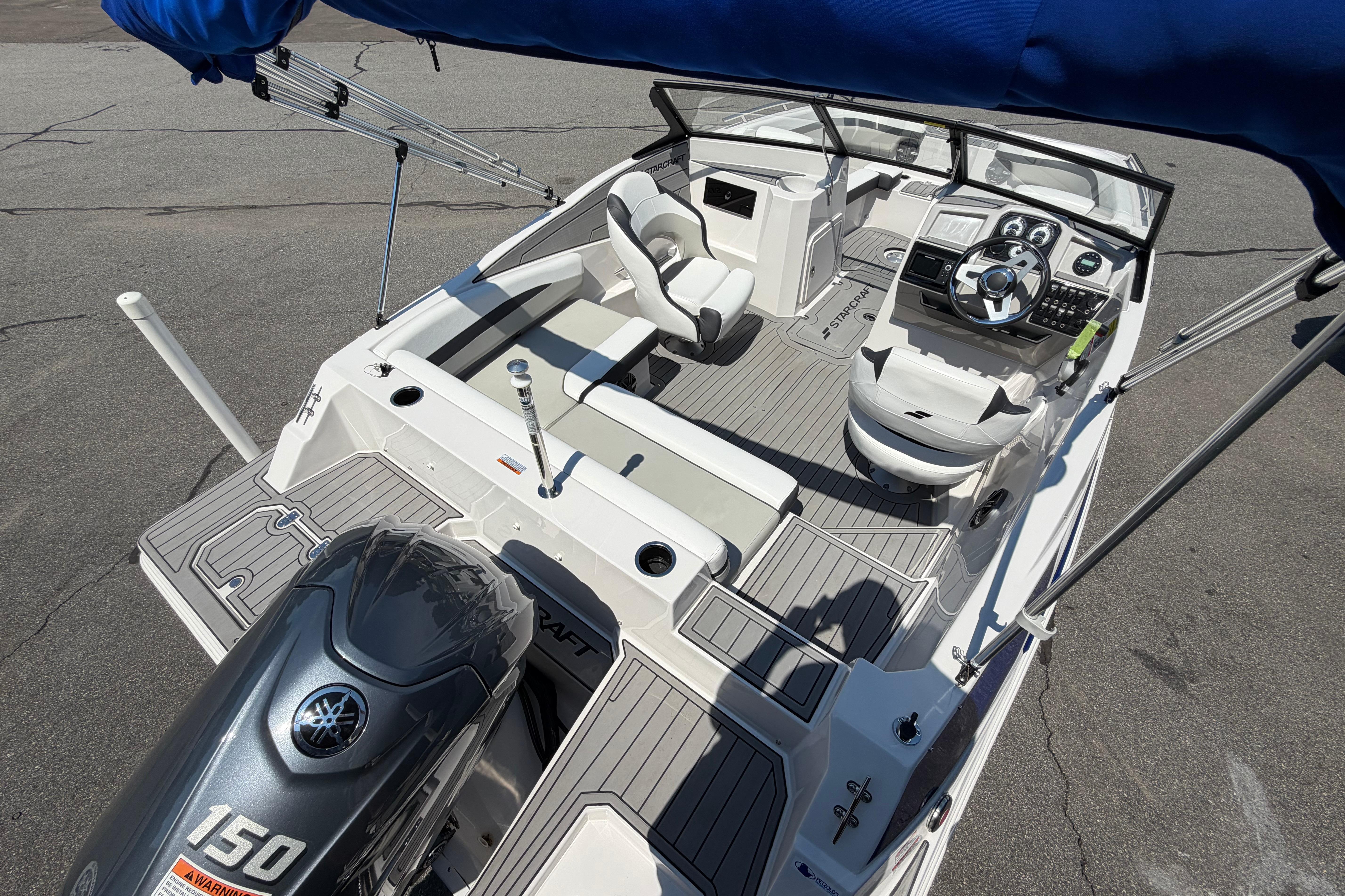 2025 Starcraft SVX 190 OB boat interior with Yamaha 150 engine, featuring modern seating and controls.