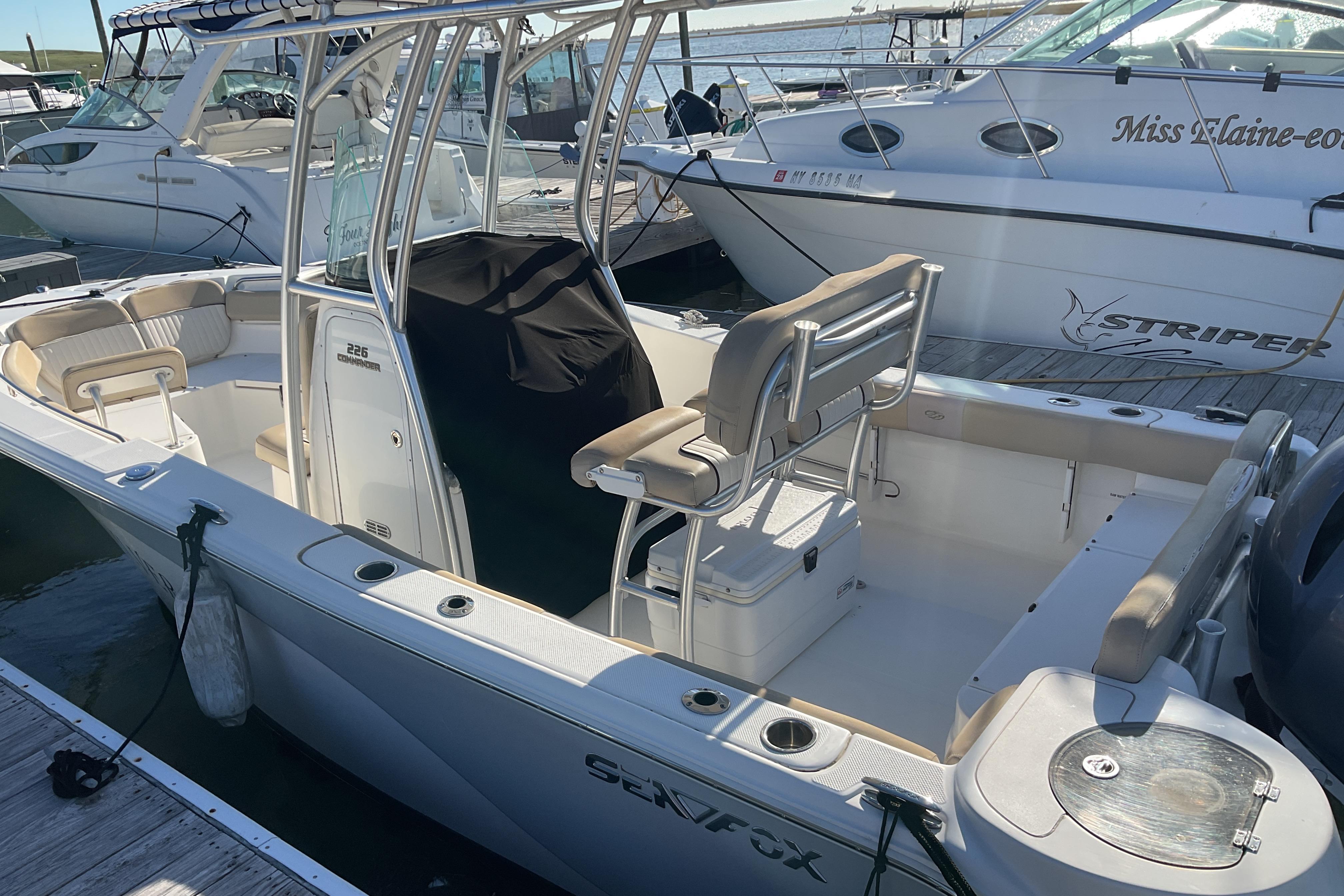 2016 Sea Fox 226 Commander boat docked, featuring spacious seating and sleek design.