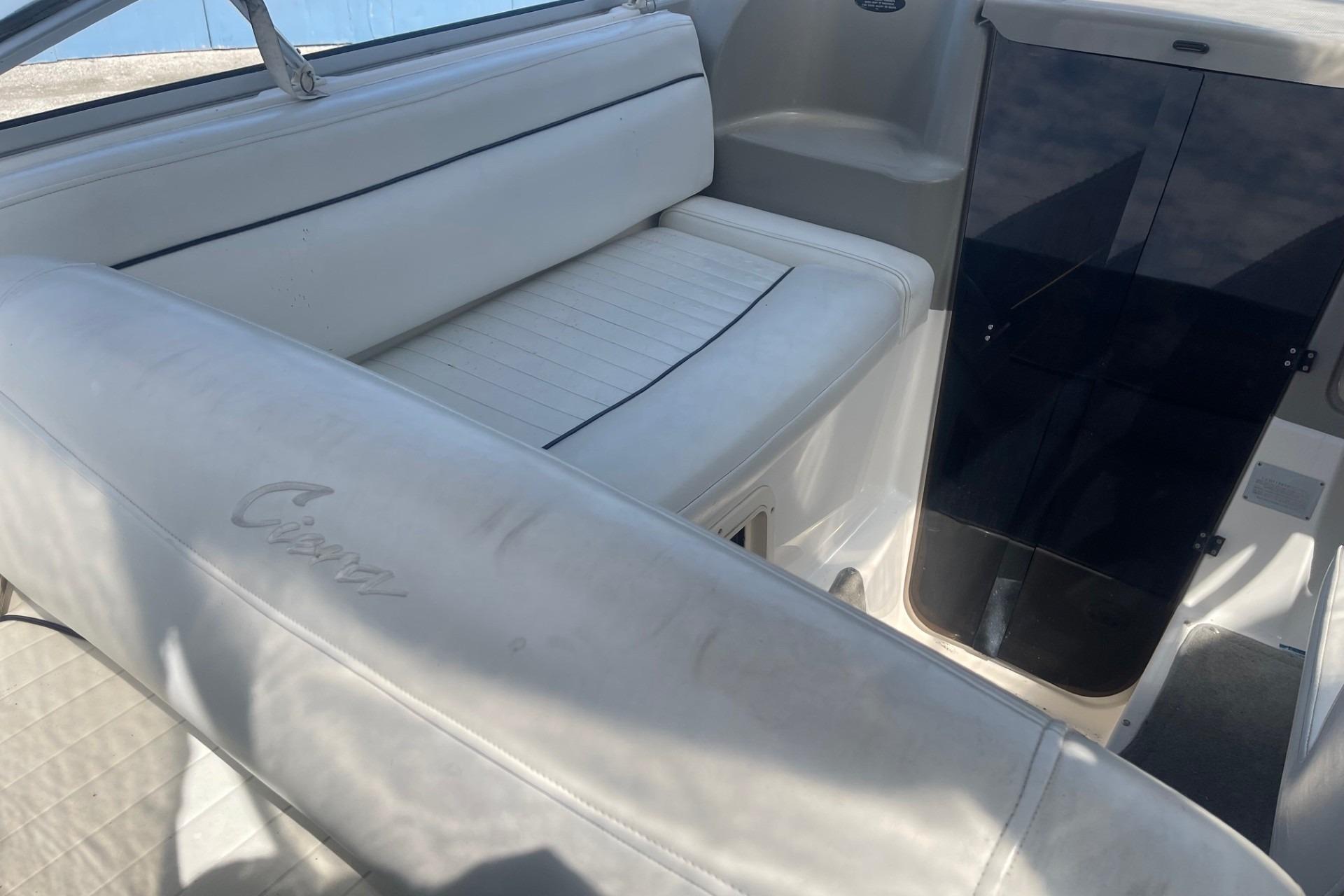 1997 Bayliner 2655 Ciera boat interior with white seating and cabin entrance.